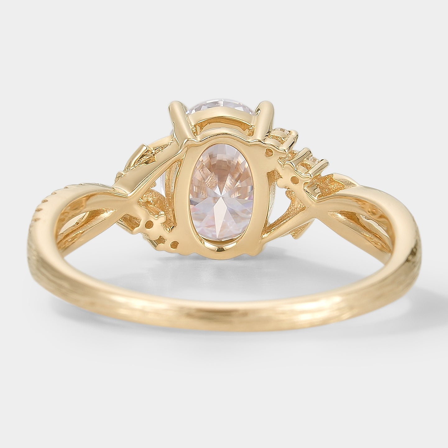 Yellow gold oval moissanite engagement ring with leaf and bark design, bridal jewelry