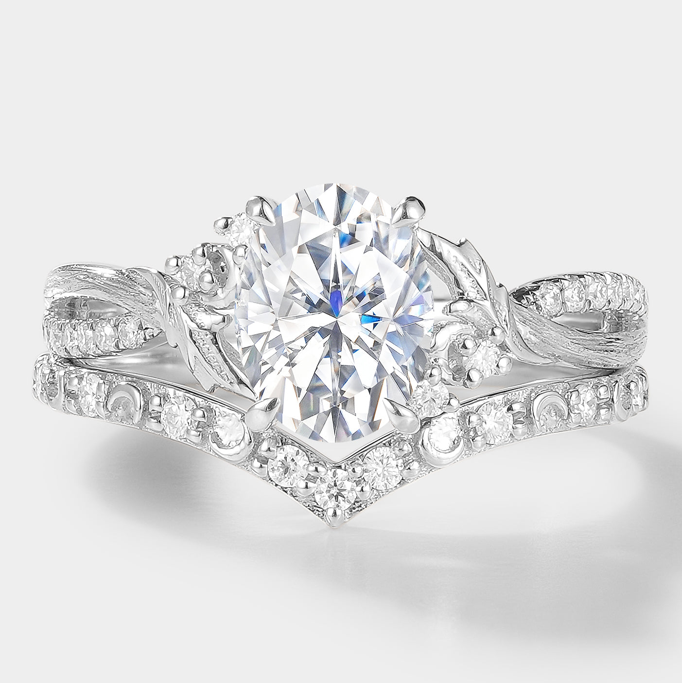 Moissanite leaf engagement ring set with oval center stone & V-shaped wedding band in white gold