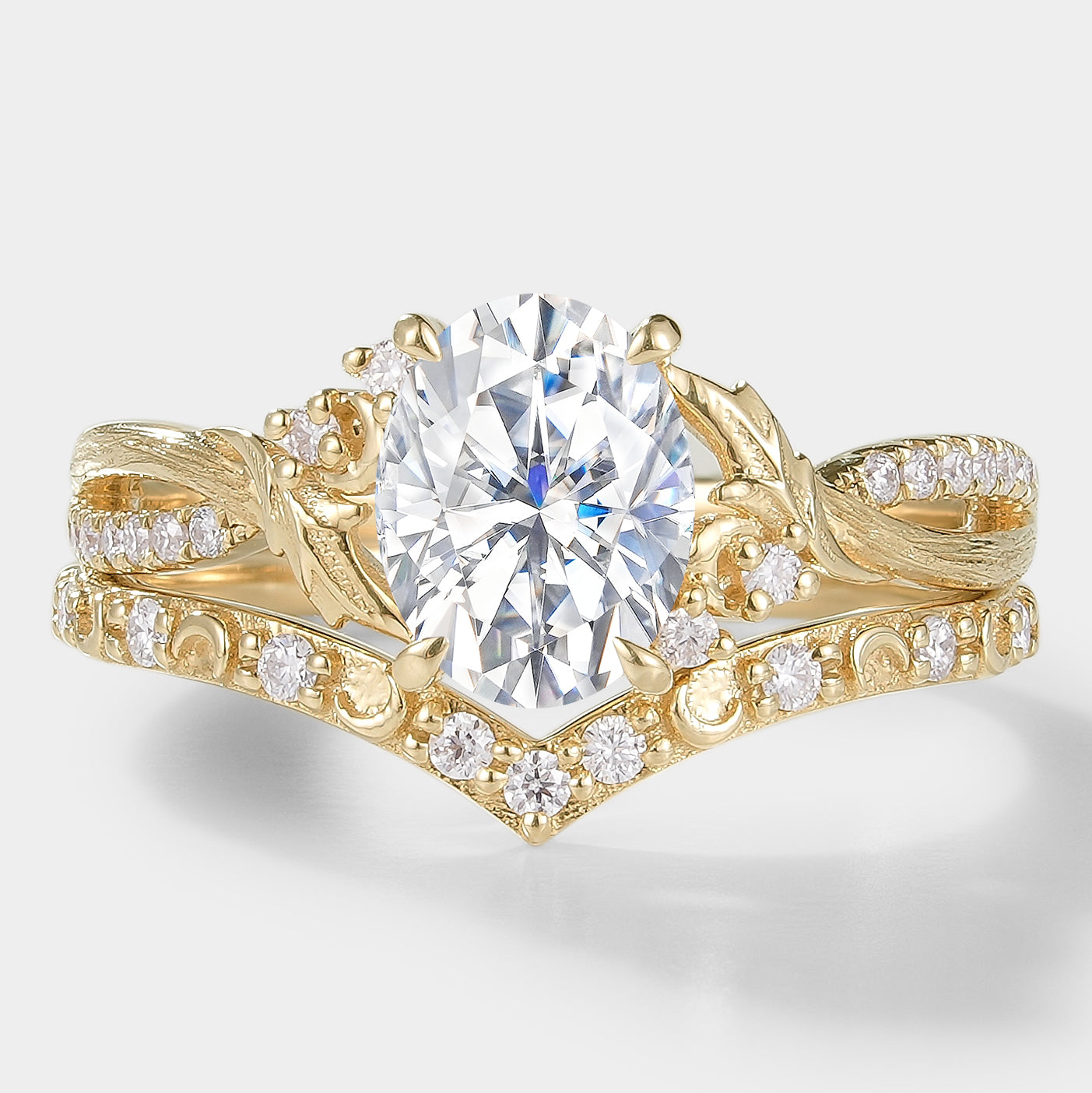 Moissanite leaf engagement ring set with bark texture and a V-shaped wedding band, 14k gold