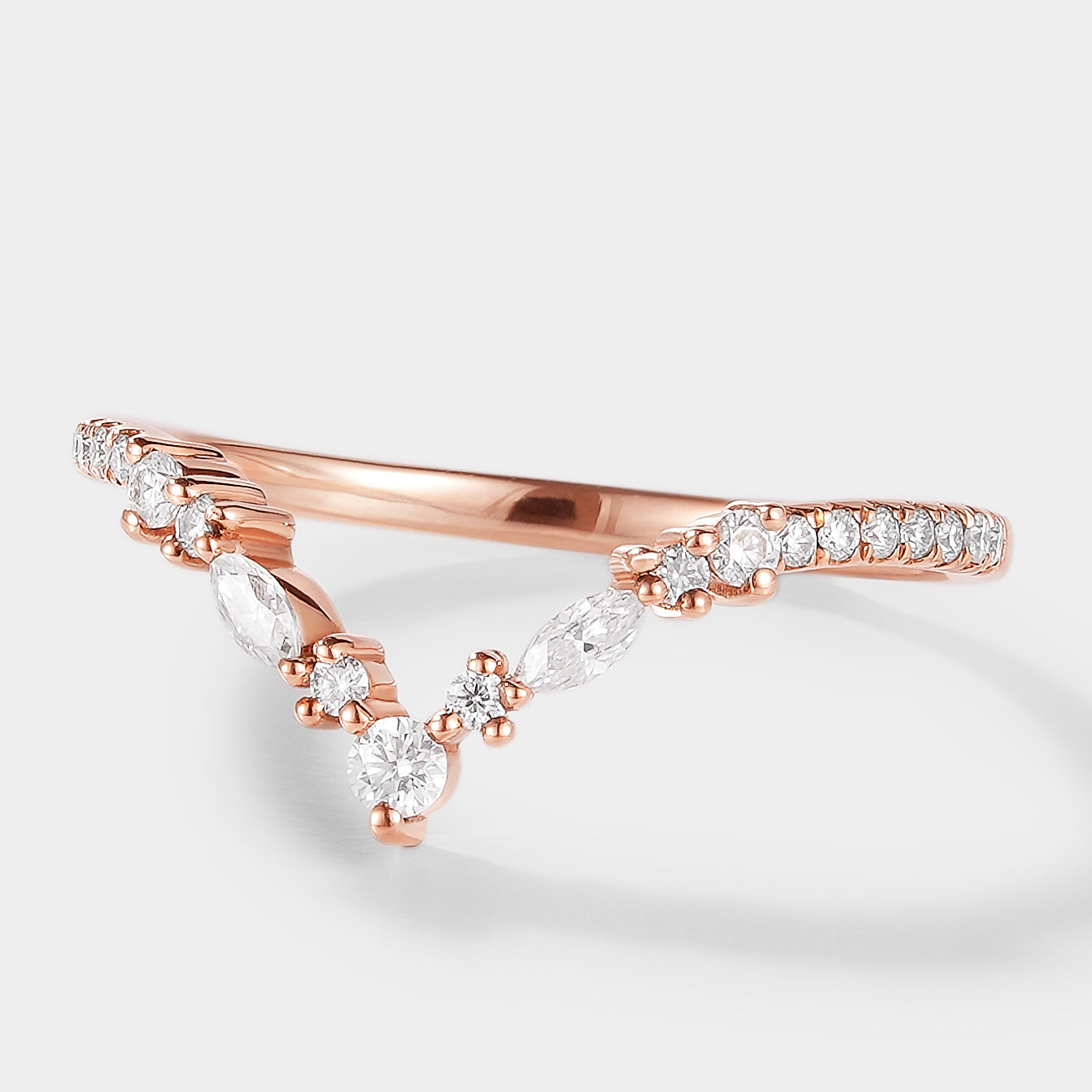 Rose gold Elara moissanite wedding band with unique curved design