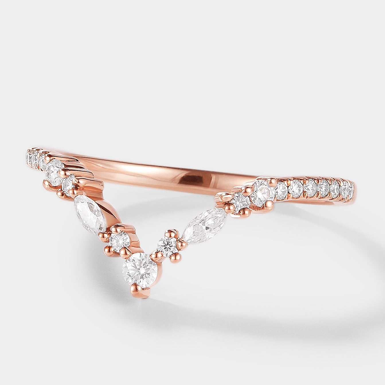 Rose gold Elara moissanite wedding band with unique curved design