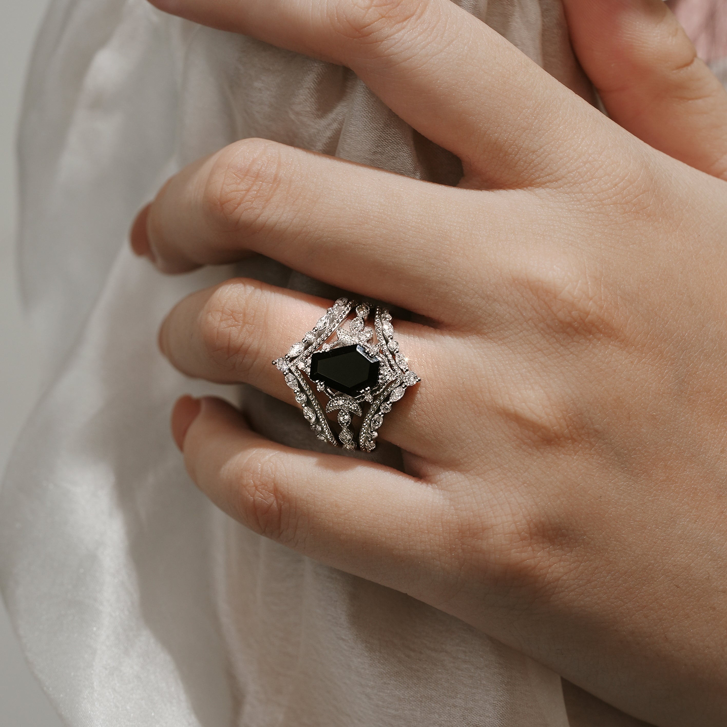 Black onyx coffin cut engagement ring set on a hand