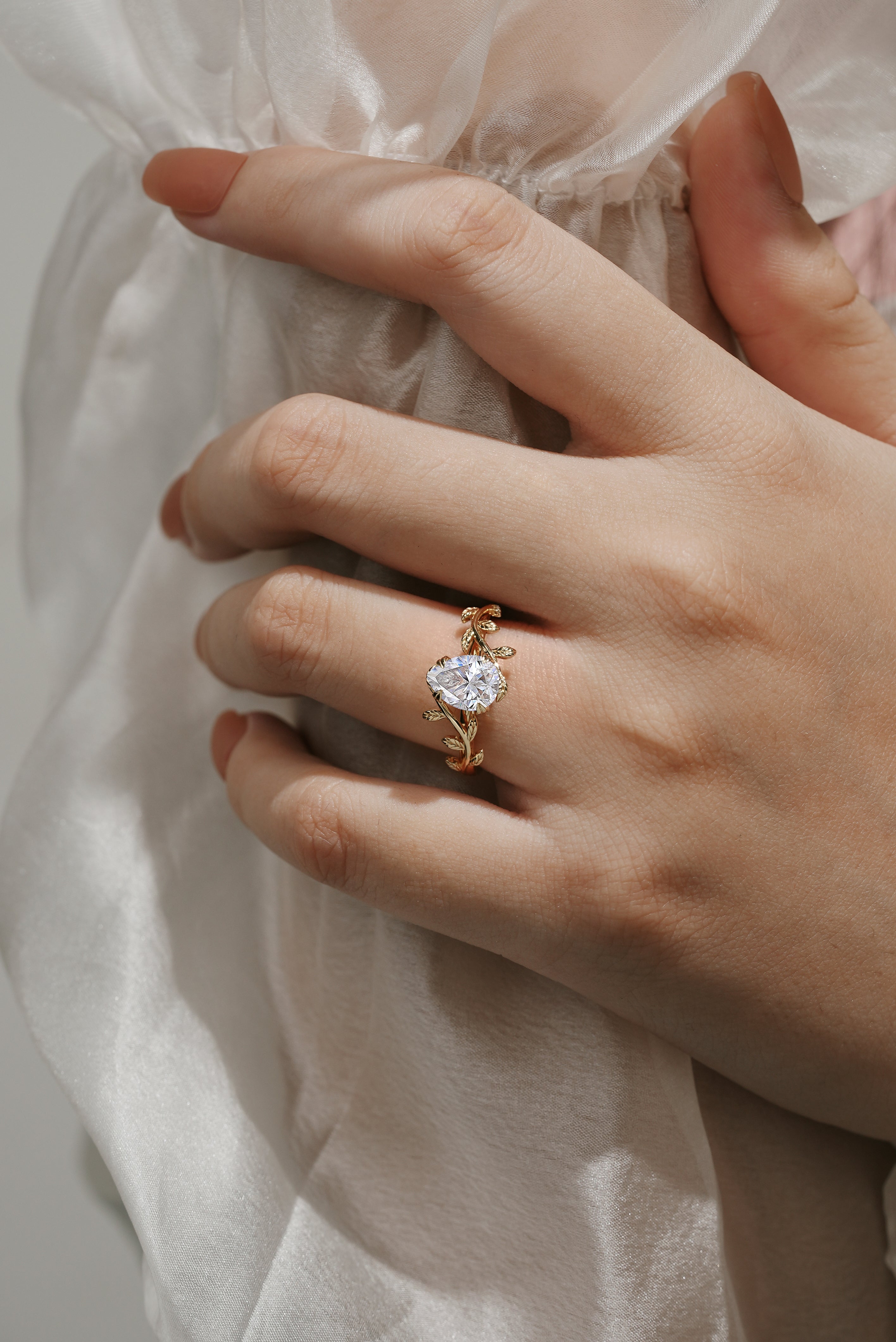 Nature-inspired leaf engagement ring with pear-cut moissanite gemstone
