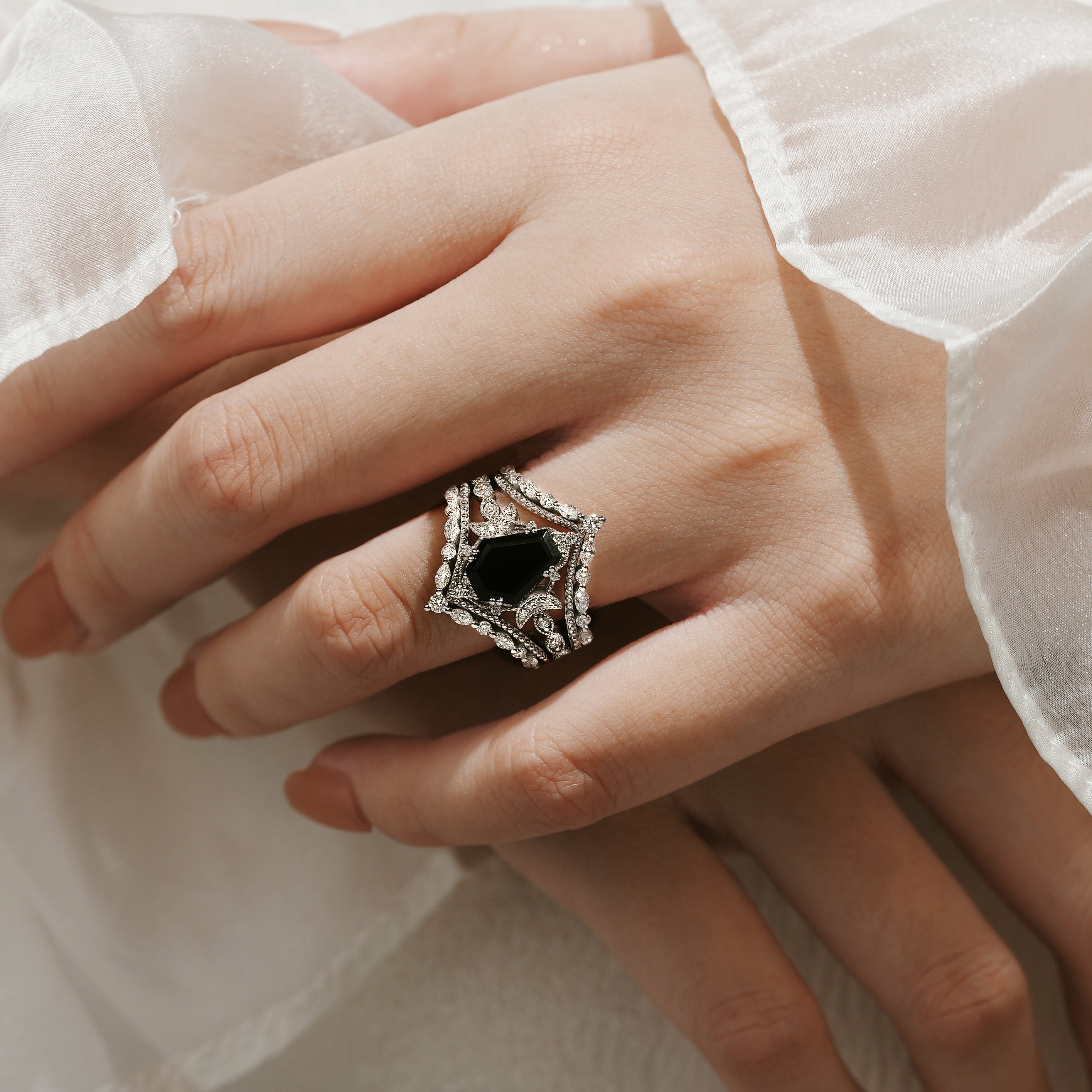 Elegant coffin cut black onyx engagement ring on a hand