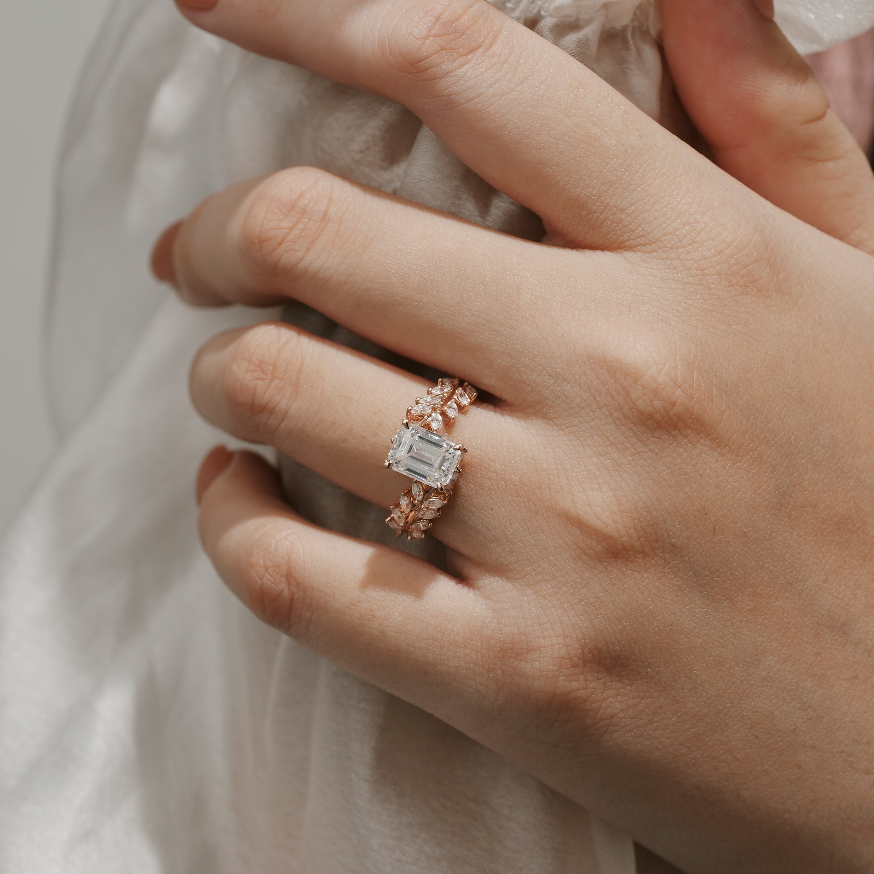 Emerald Cut Moissanite Leaf Engagement Ring on hand