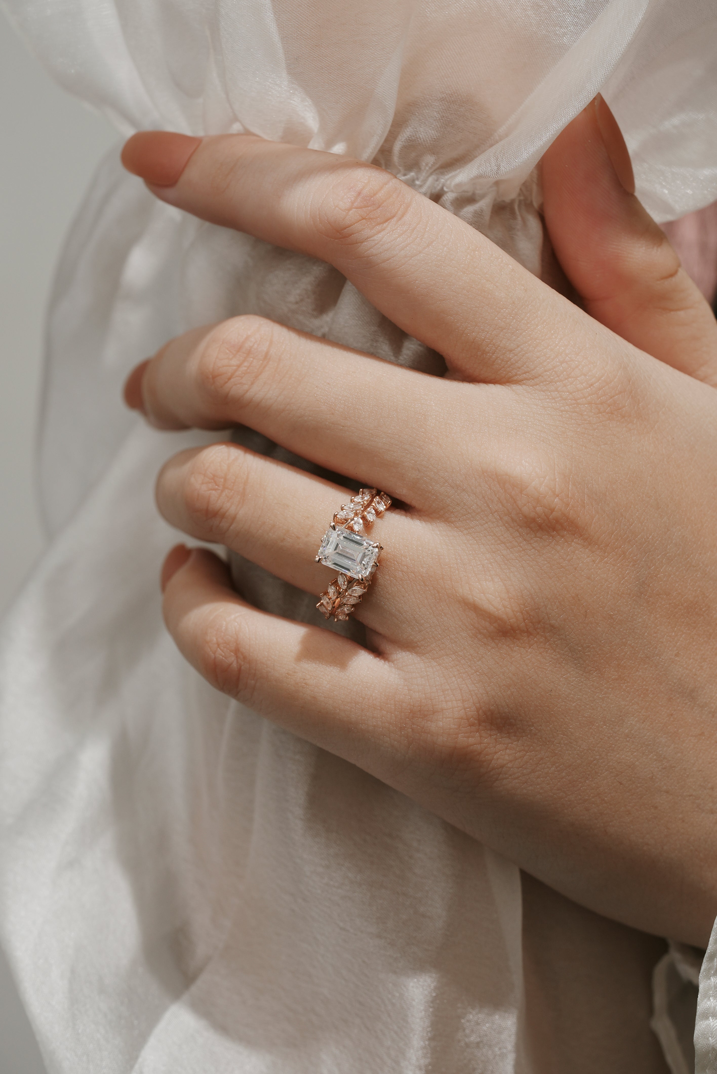 Emerald Cut Moissanite Leaf Engagement Ring on hand