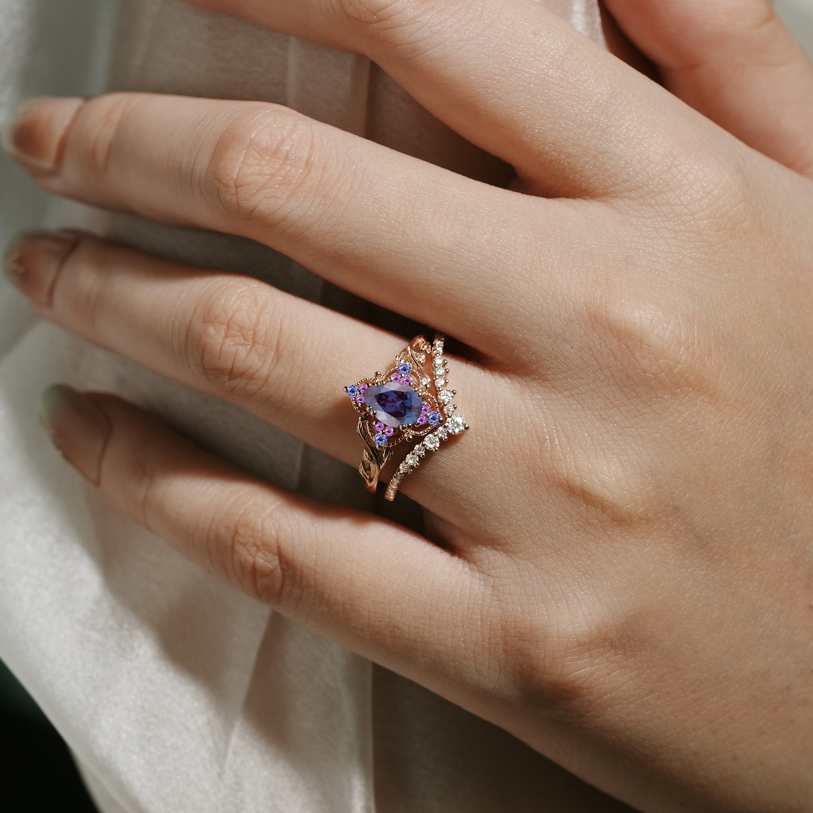 Alexandrite leaf engagement ring set on a hand