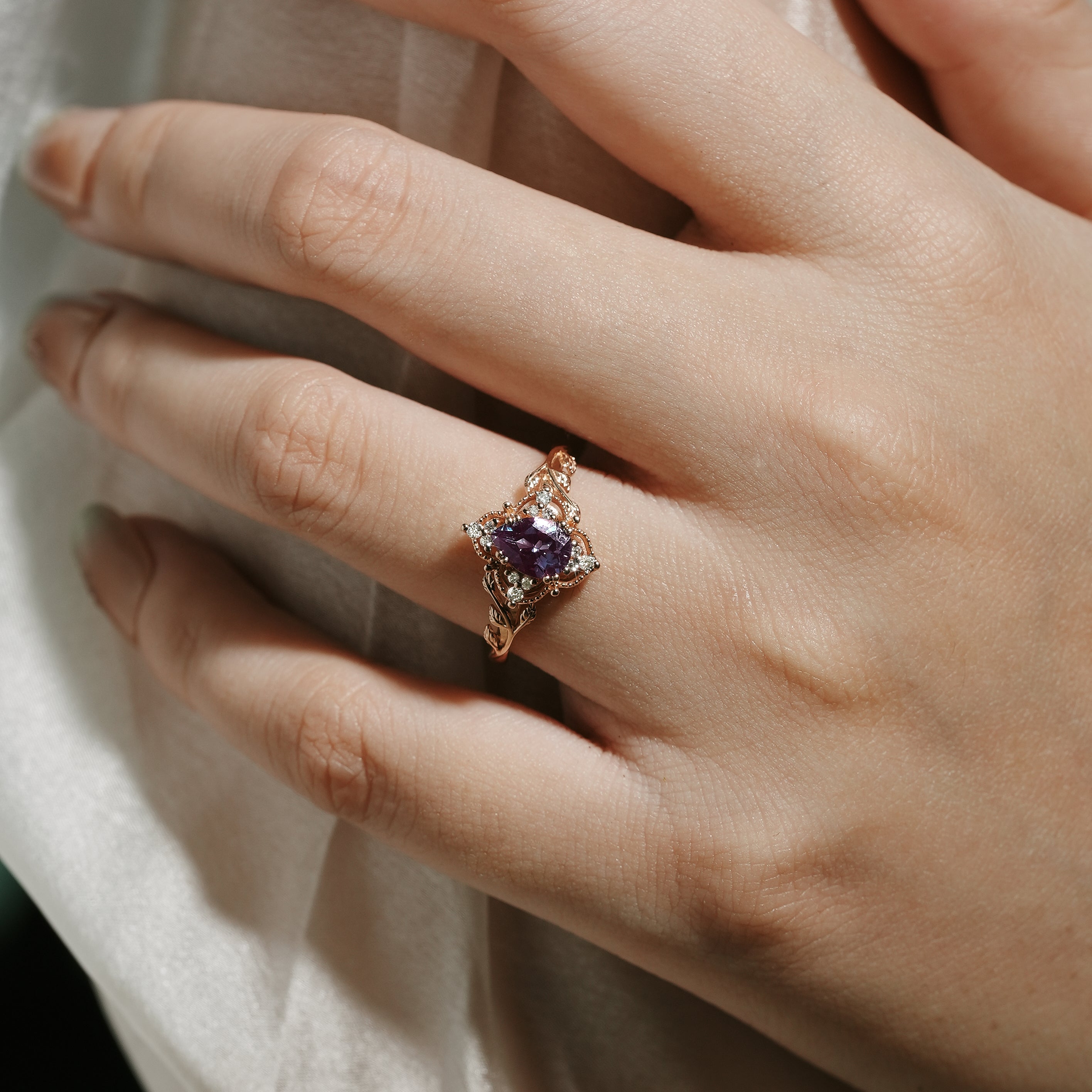 Alexandrite leaf engagement ring on a hand