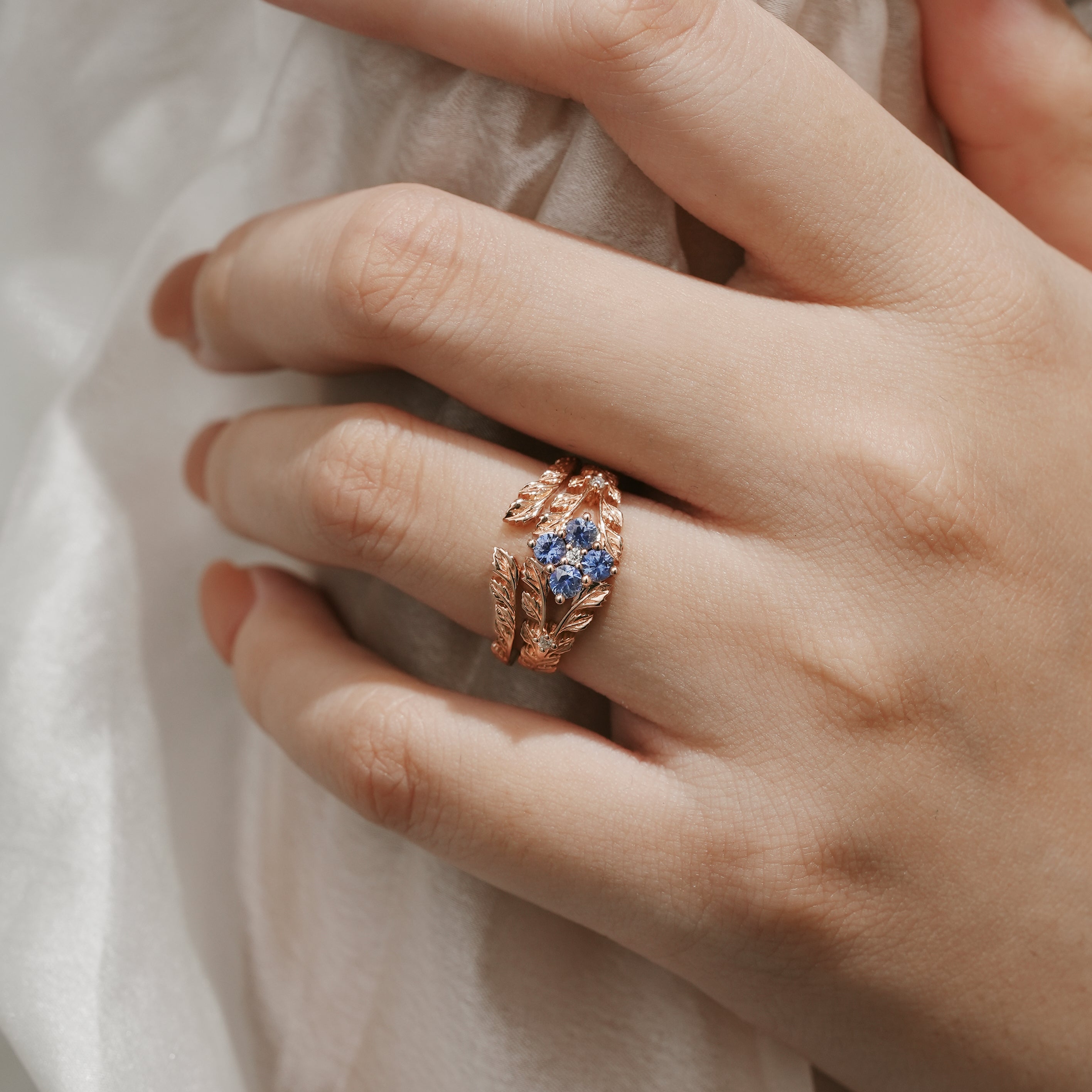 Leaf-Inspired Cornflower Sapphire Engagement Ring Set on Hand