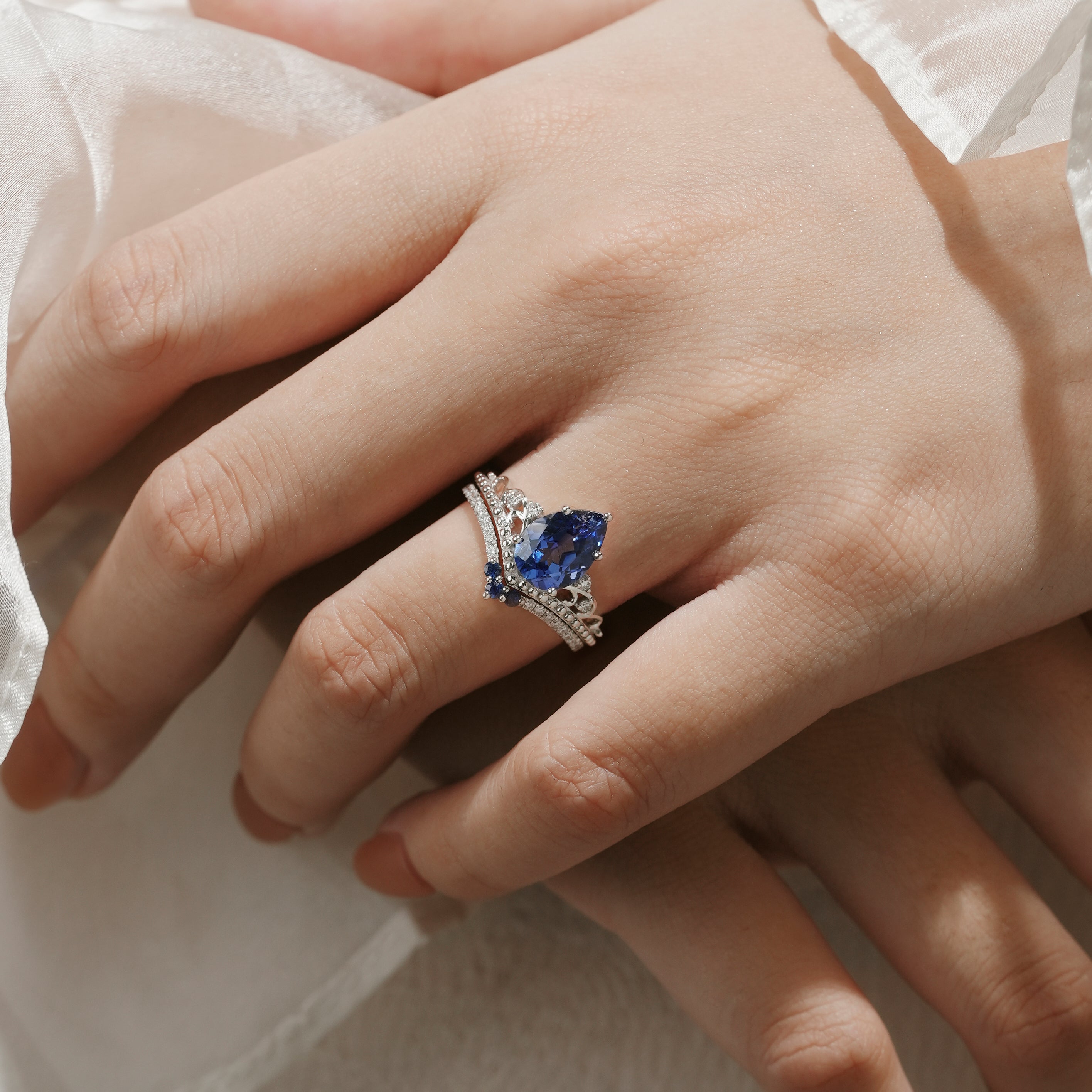 Woman's hand wearing vintage Cornflower sapphire engagement ring set