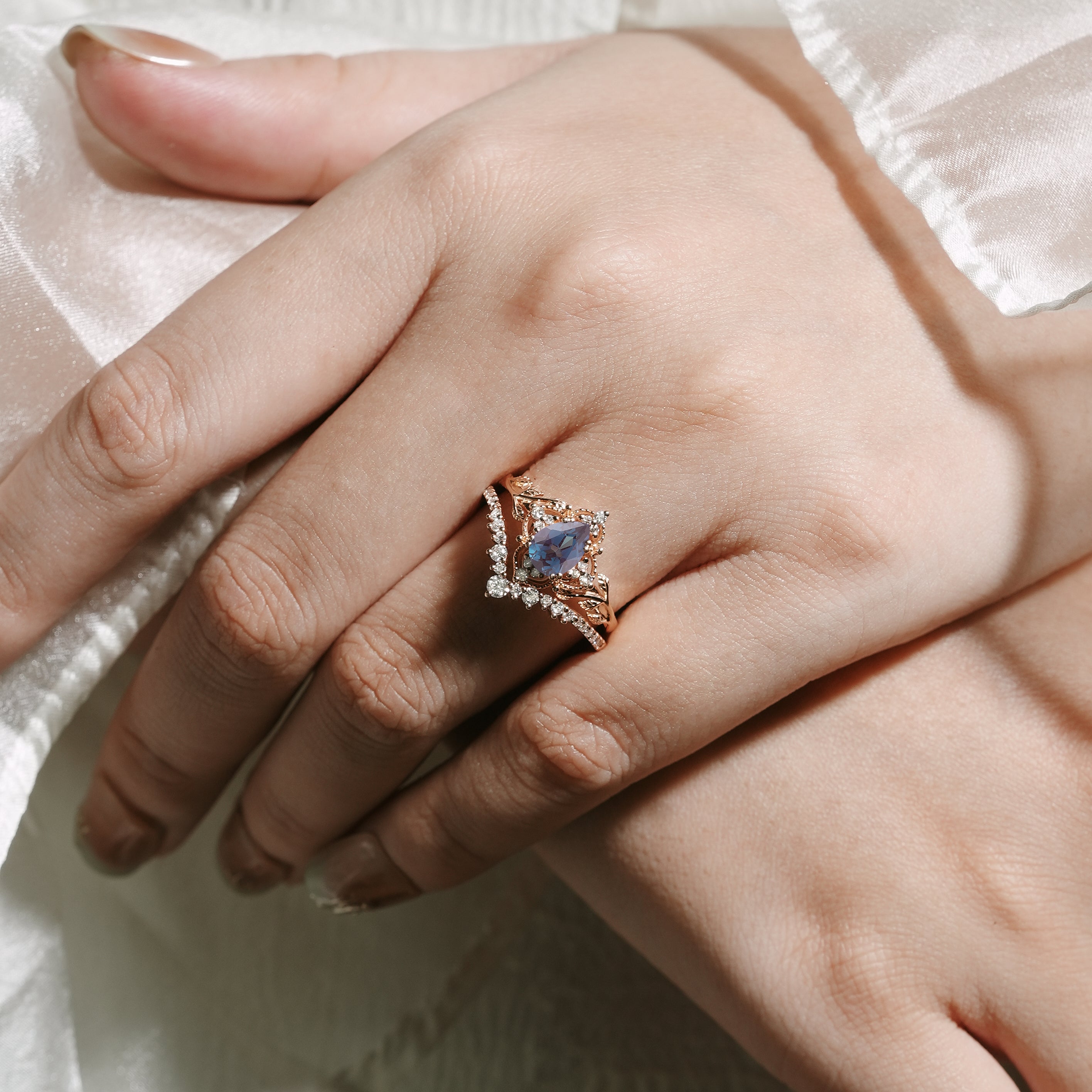 Rose gold pear-cut alexandrite bridal set with leaf details, moissanite accents, vintage style ring set
