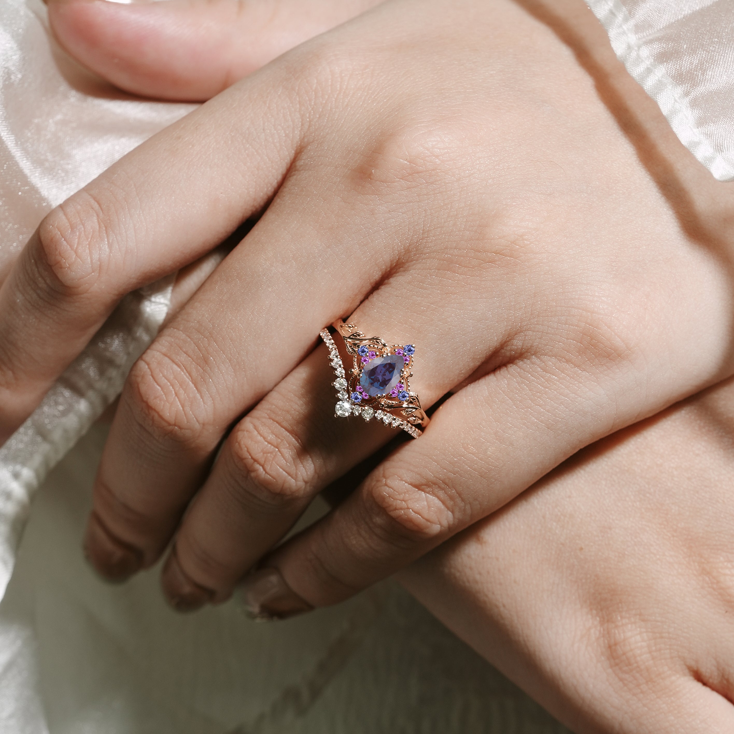 Woman's hand wearing leaf alexandrite engagement ring set