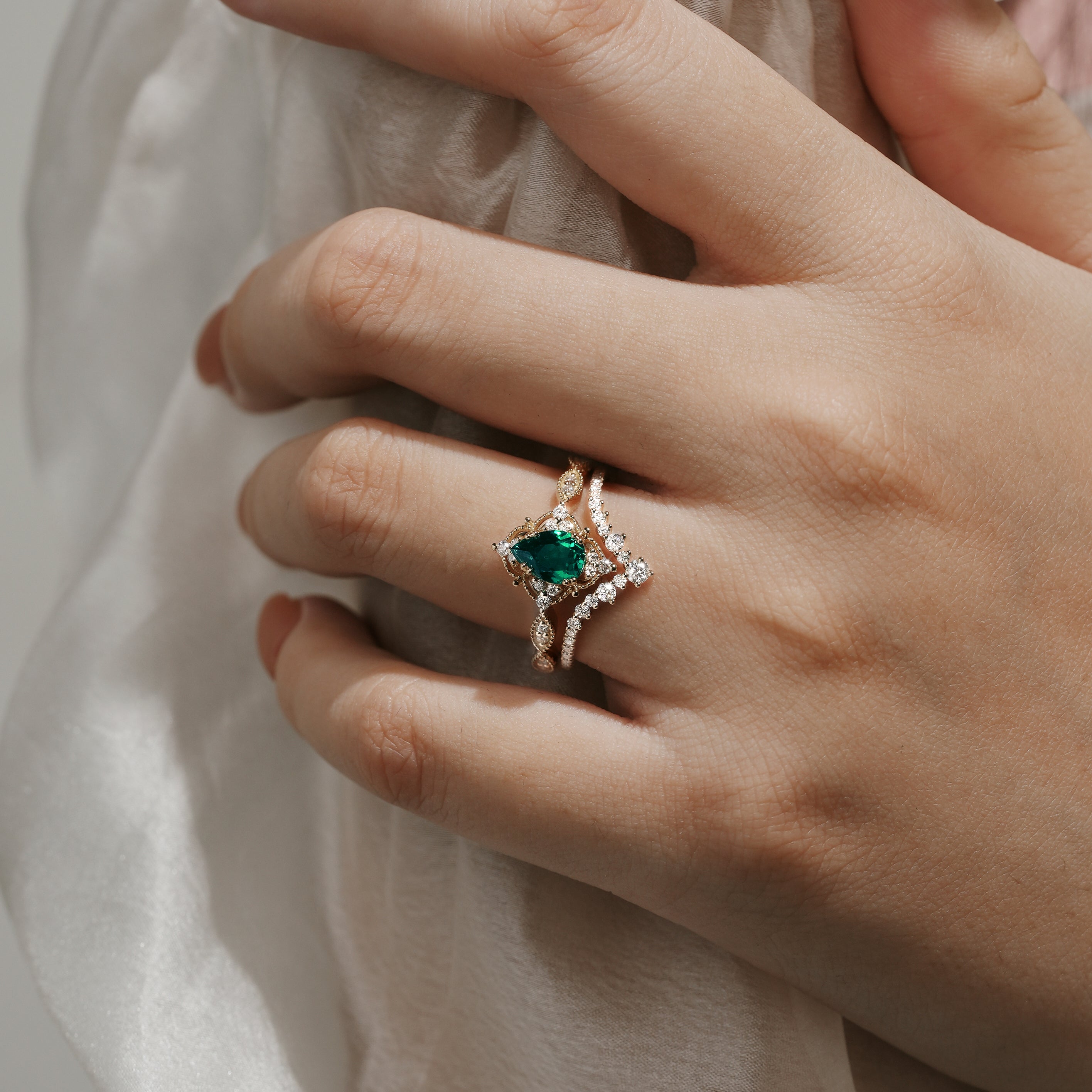 Elegant Lab Emerald Engagement Ring Bridal Set on a hand