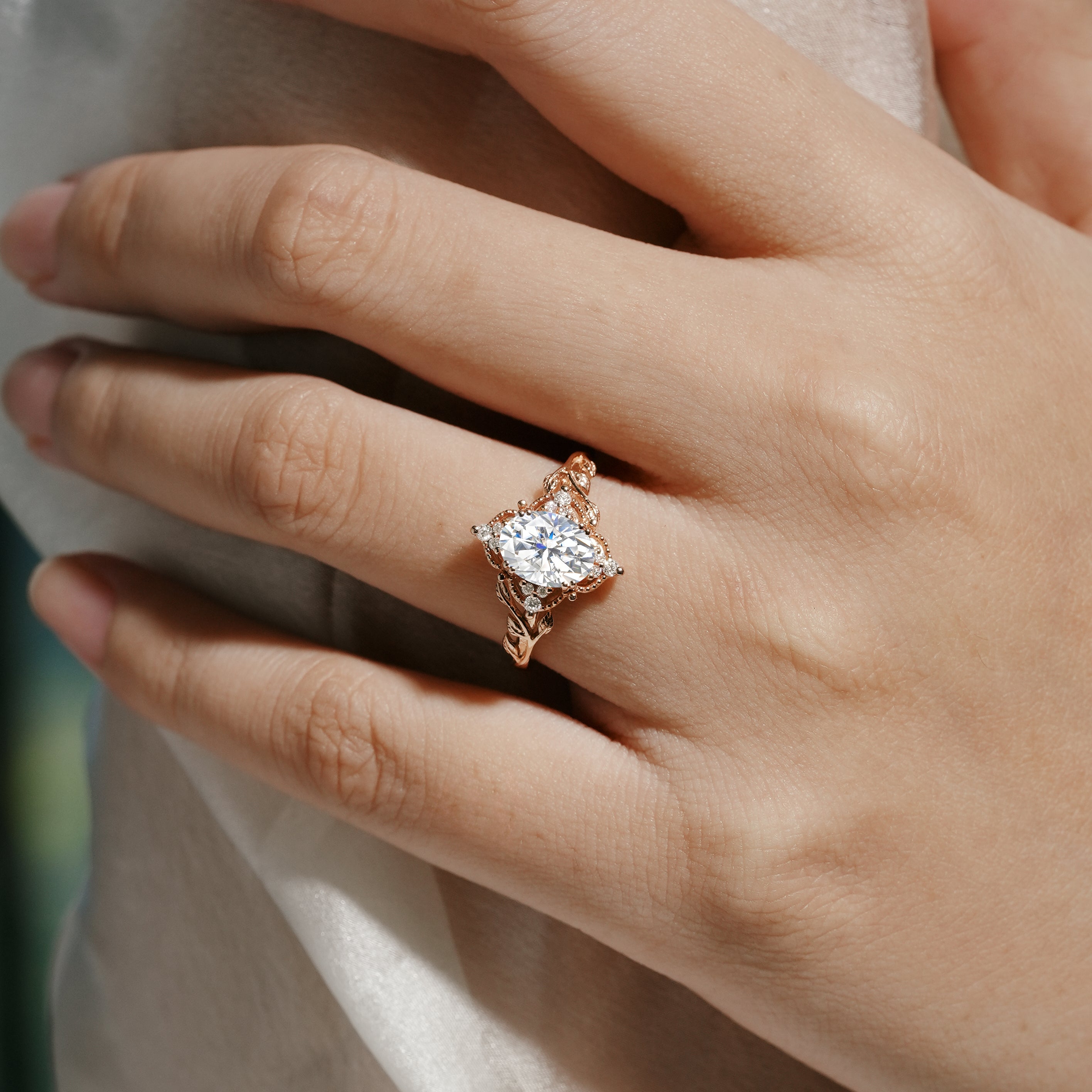 Rose gold leaf engagement ring featuring oval cut moissanite, bridal jewelry