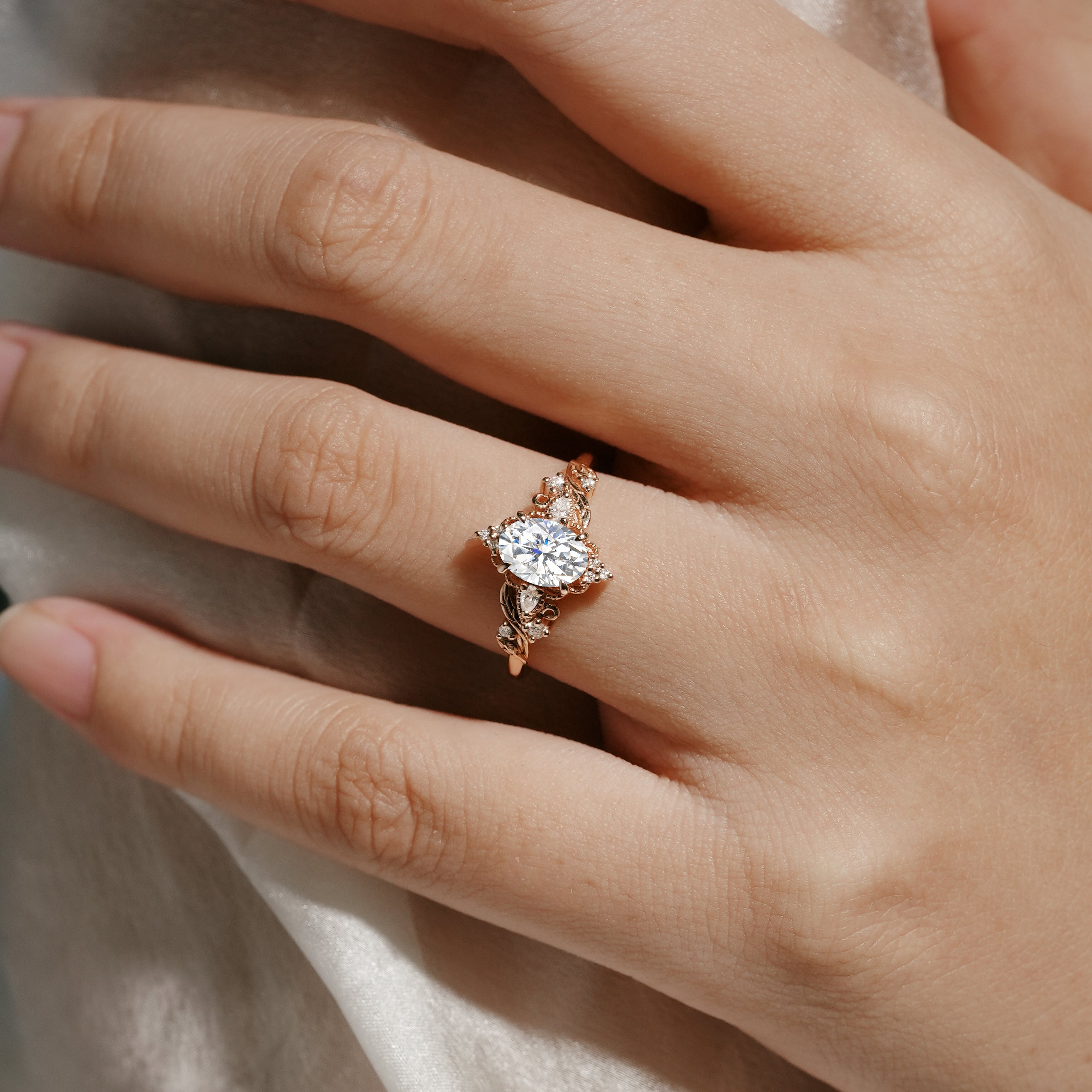 Oval moissanite engagement ring with leaf design in rose gold. Lahela Jewelry Aurelia ring, bridal set.