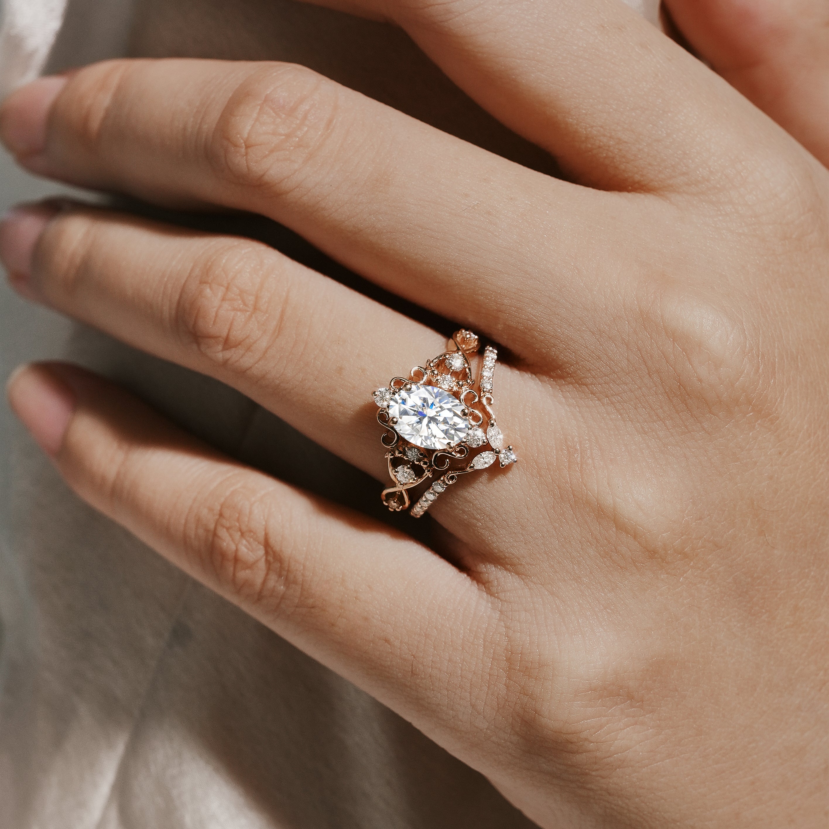 Vintage moissanite engagement ring set, rose gold with oval cut center stone and accent stones, wedding band