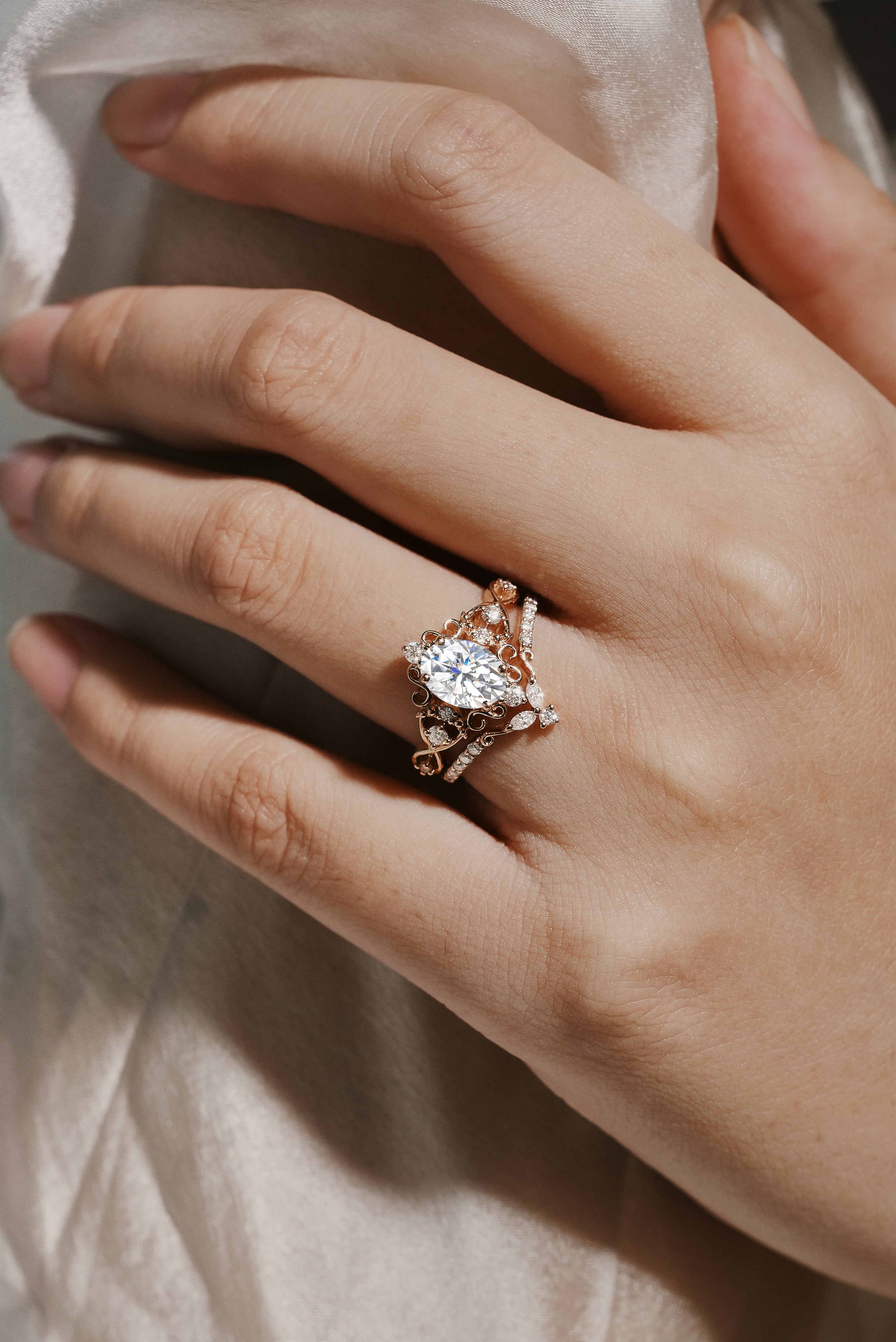 Vintage moissanite engagement ring set, rose gold with oval cut center stone and accent stones, wedding band