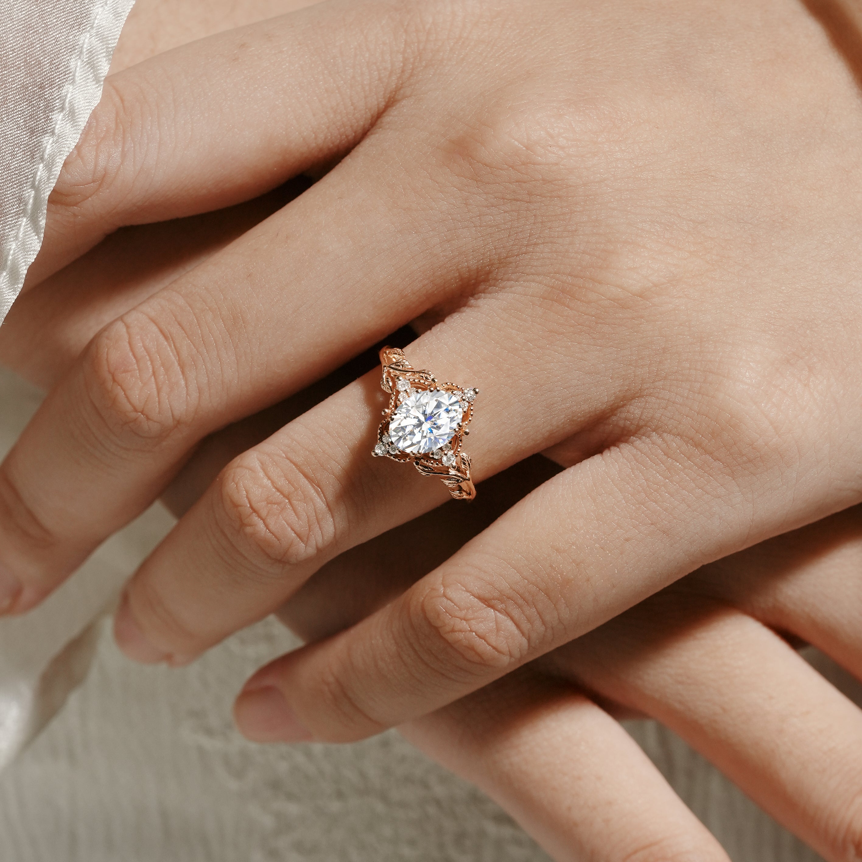 Rose gold moissanite leaf engagement ring on a hand, bridal jewelry. Sylva ring.