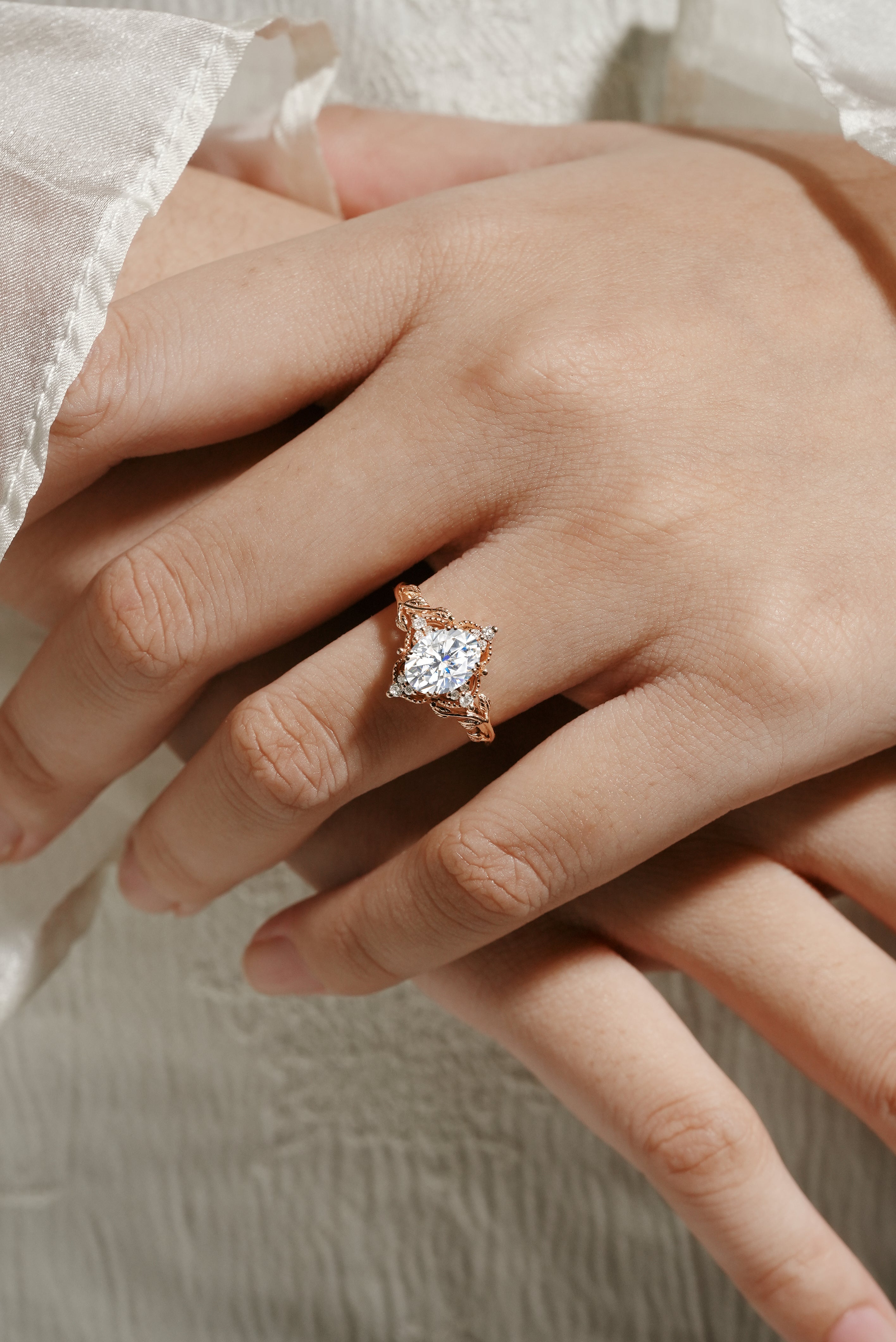 Rose gold moissanite leaf engagement ring on a hand, bridal jewelry. Sylva ring.