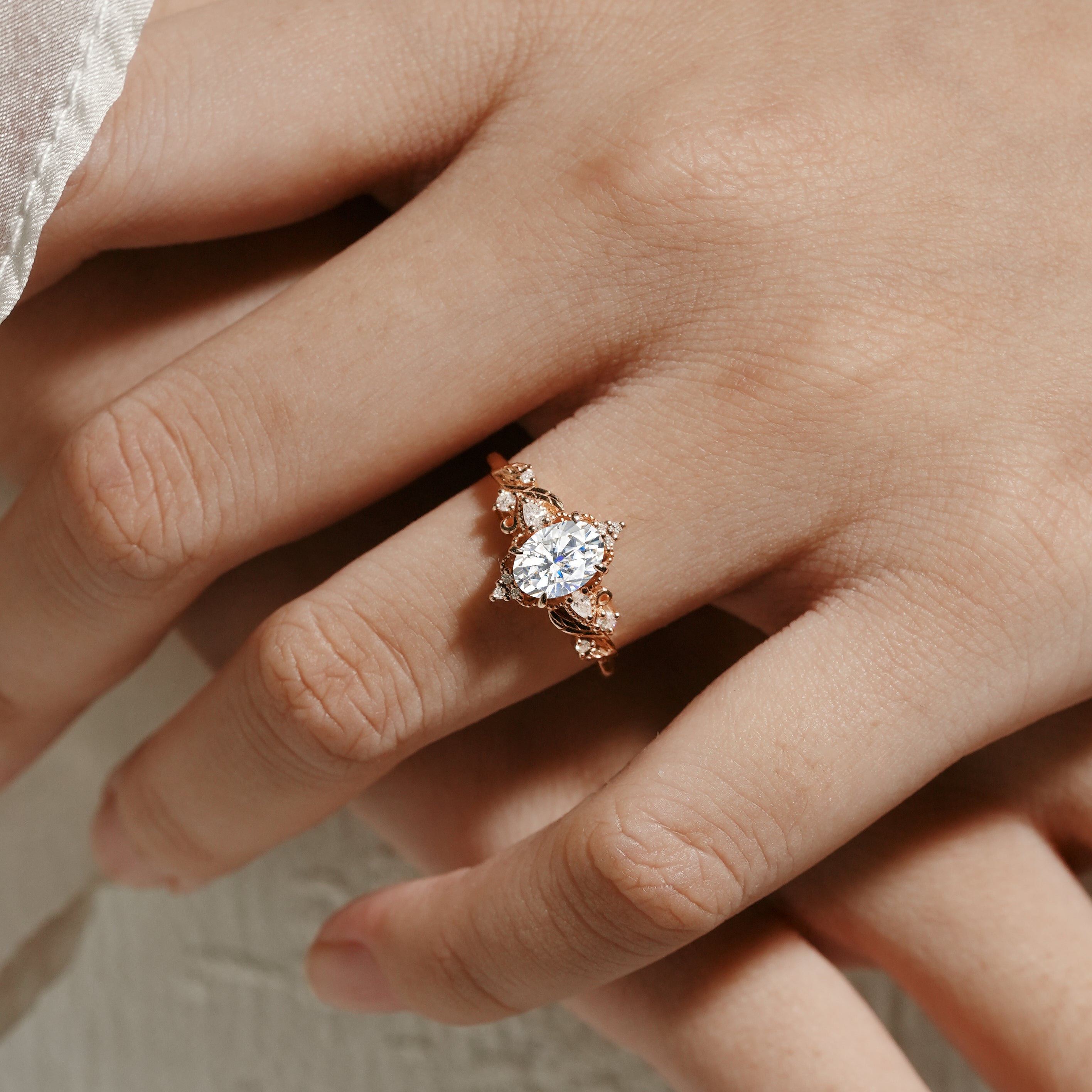 Rose gold Aurelia engagement ring with oval moissanite and leaf design, Lahela Jewelry.