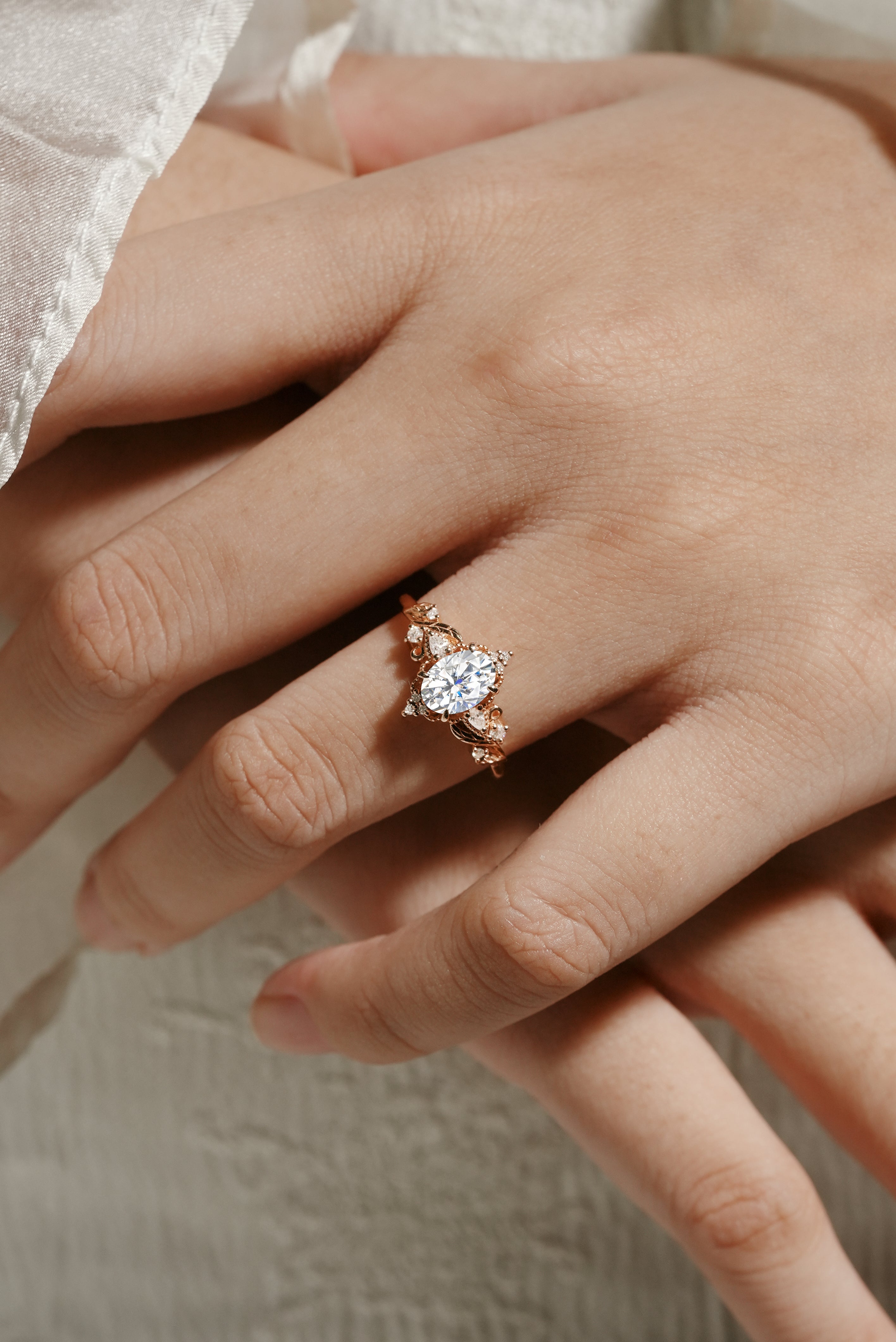 Rose gold Aurelia engagement ring with oval moissanite and leaf design, Lahela Jewelry.
