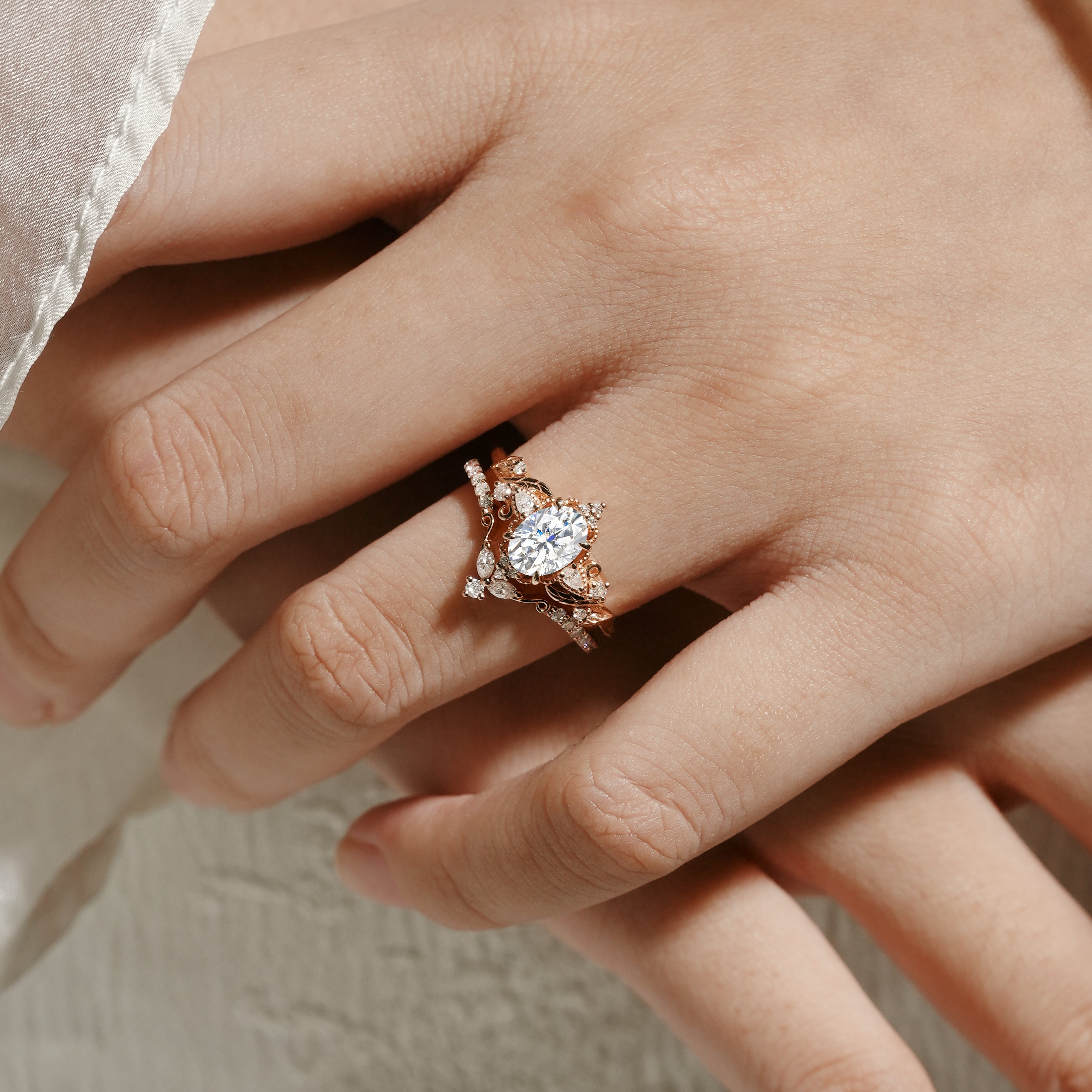 Rose gold moissanite ring set on hand, leaf design, bridal ring set. Oval cut moissanite engagement ring & wedding band.