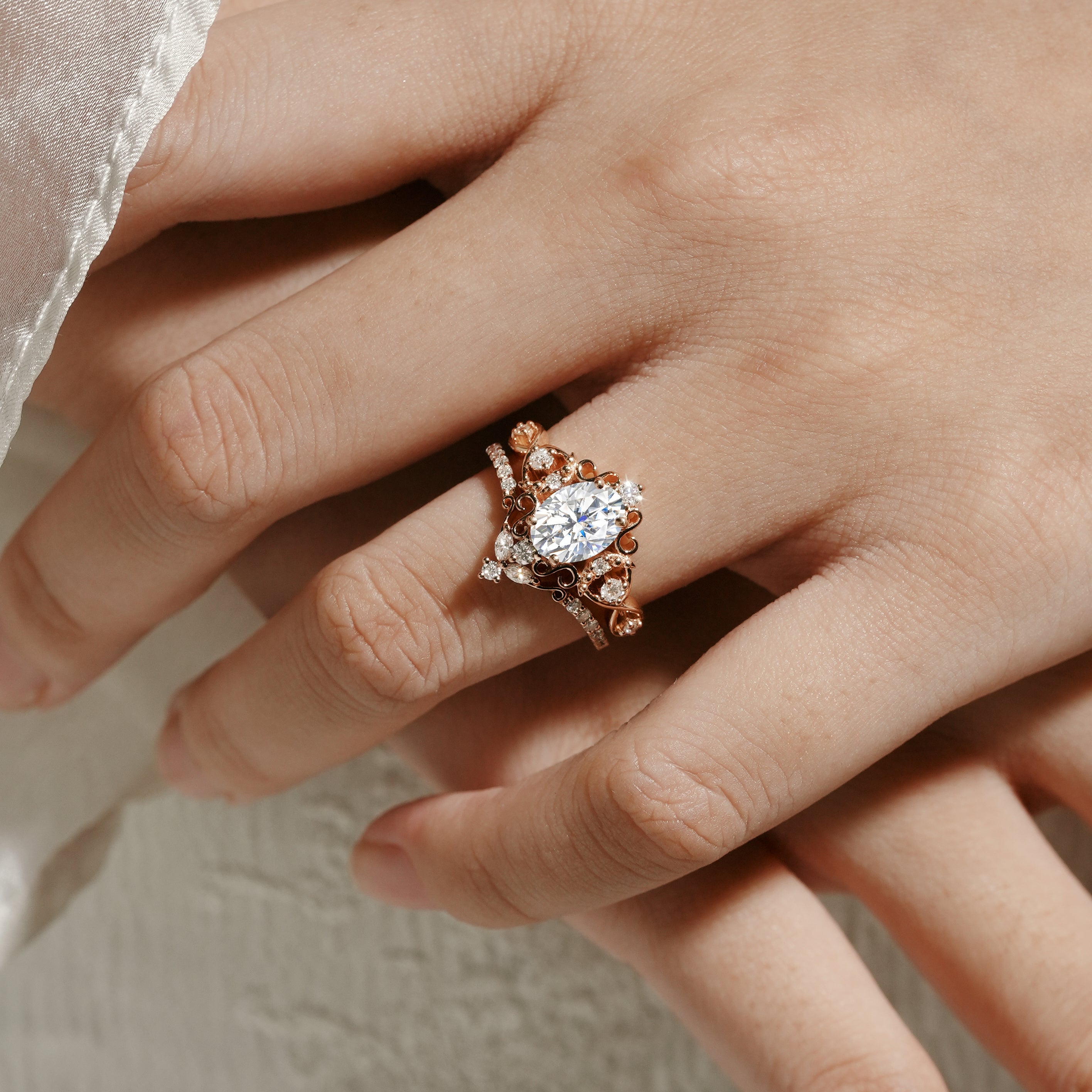 Rose gold vintage moissanite bridal set on hand, oval cut engagement ring and moissanite wedding band