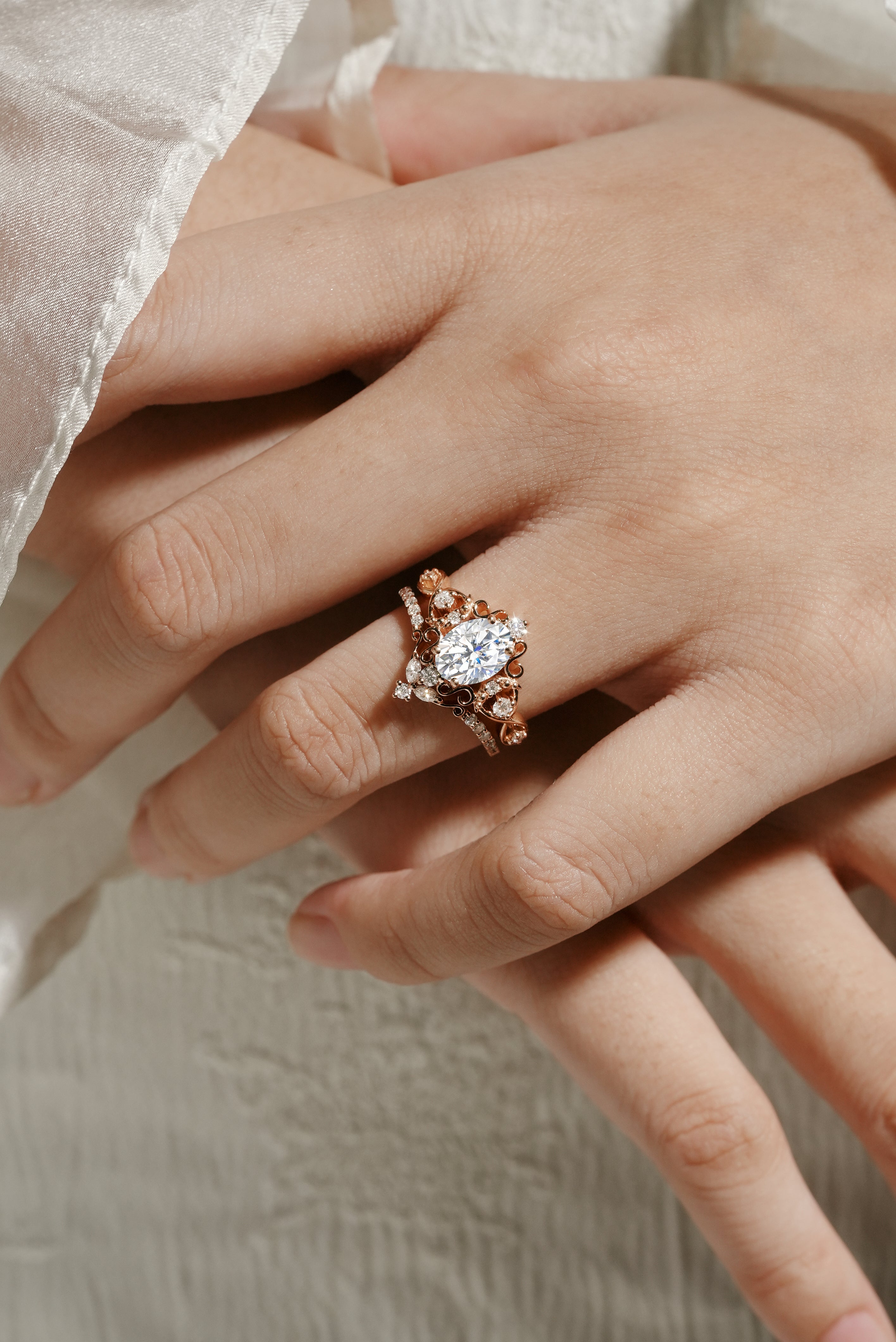 Rose gold vintage moissanite bridal set on hand, oval cut engagement ring and moissanite wedding band