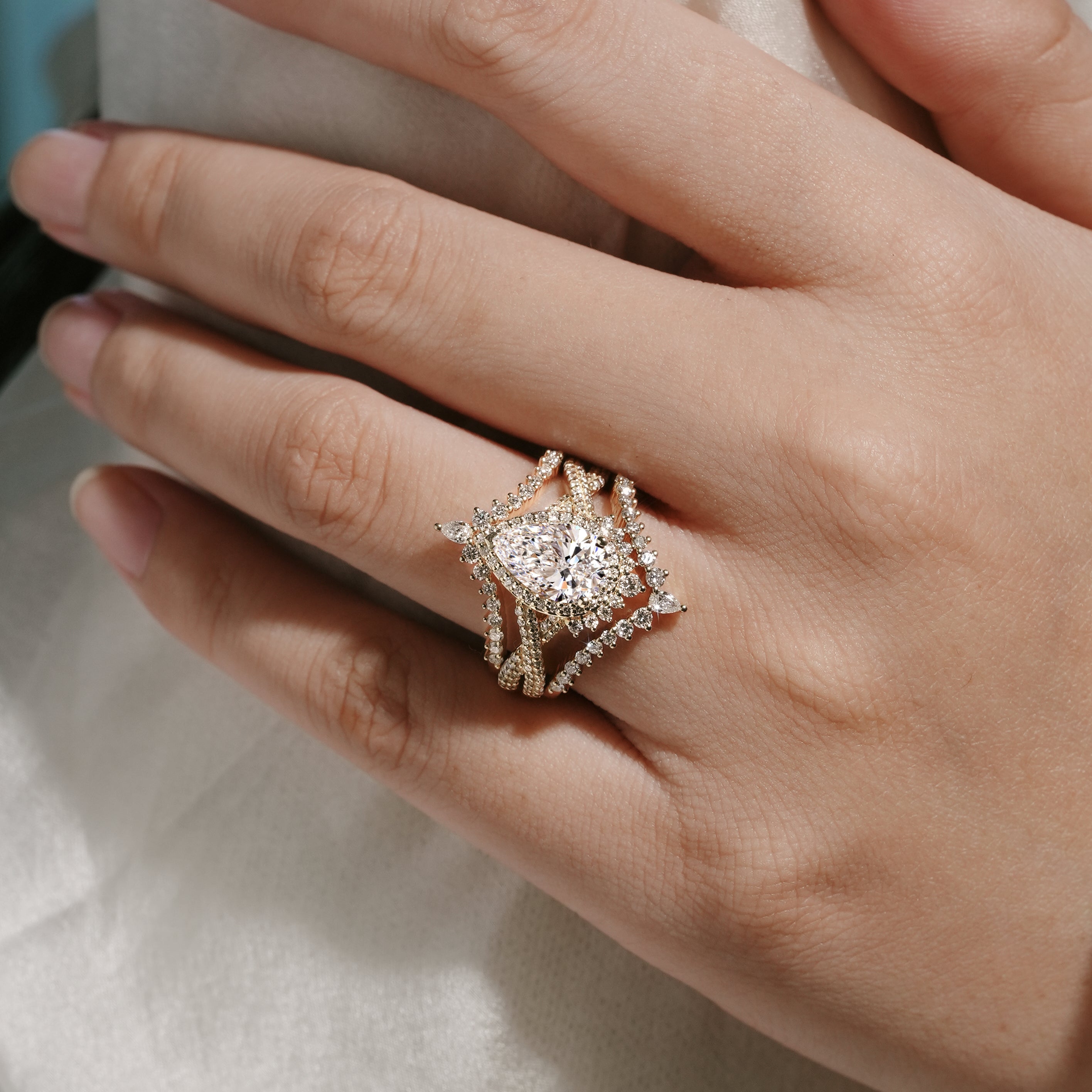 Woman's hand wearing a 3-piece lab-grown diamond engagement ring set, Lahela Jewelry