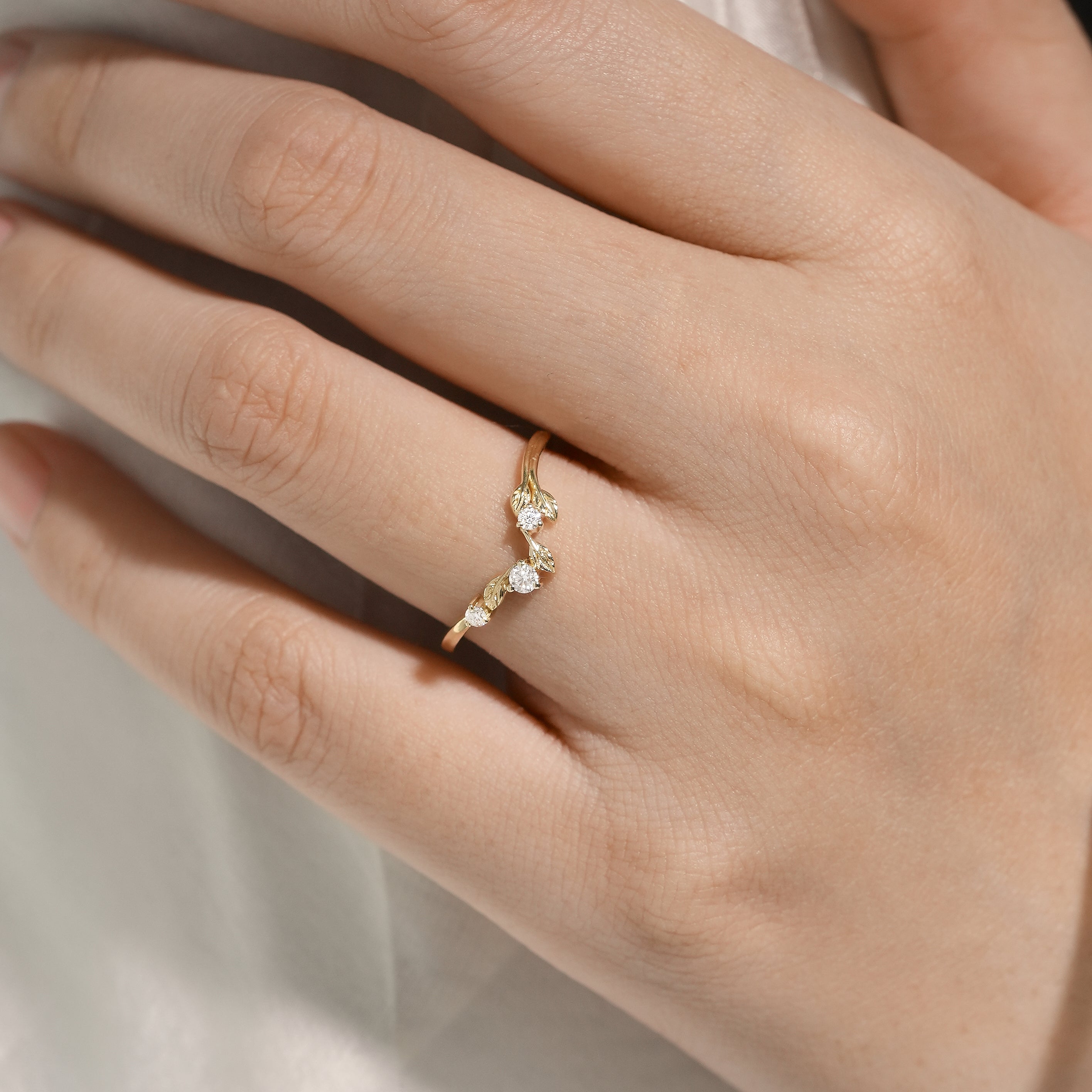 Yellow gold leaf design wedding band with moissanite stones