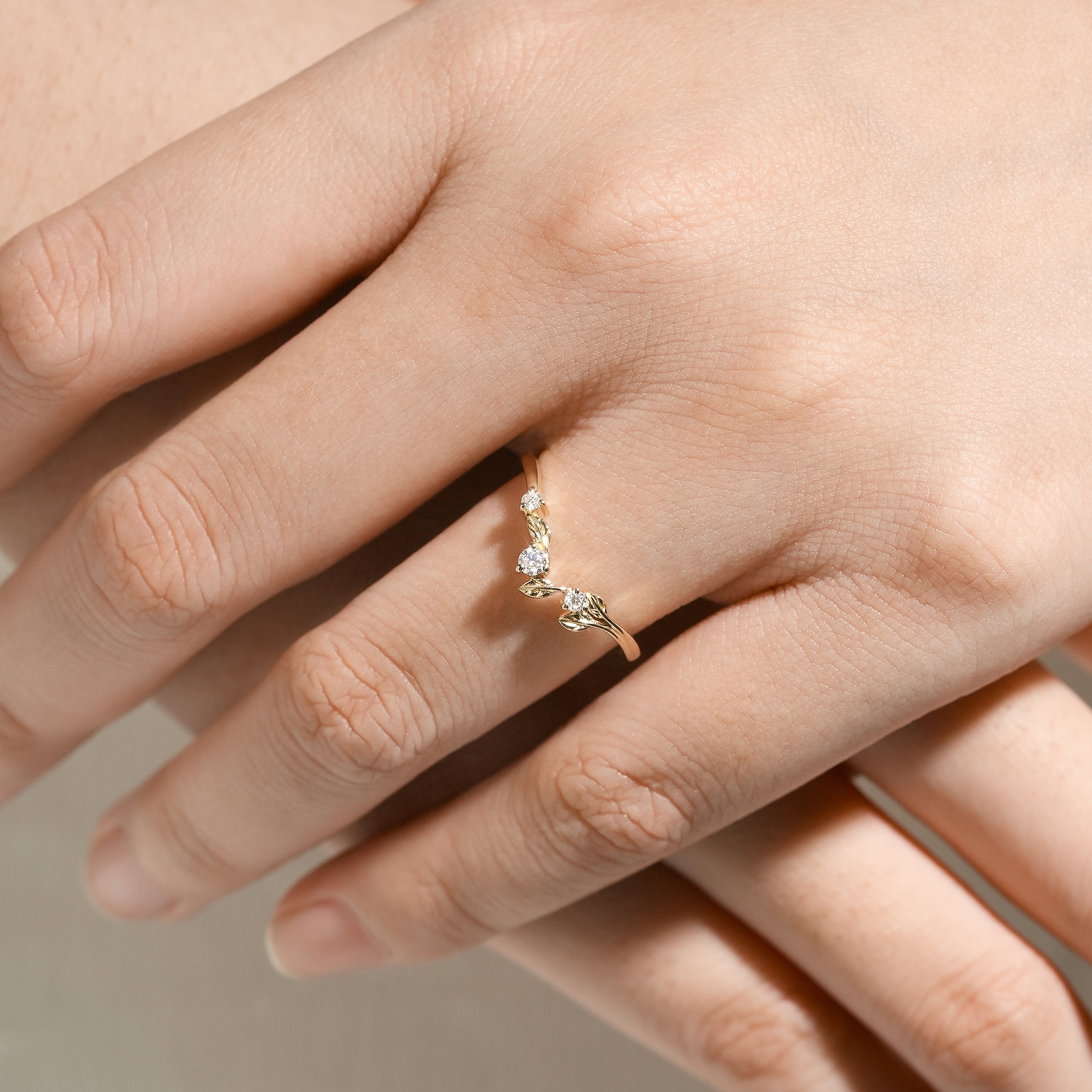 Moissanite leaf band on hand. Nature-inspired wedding ring.