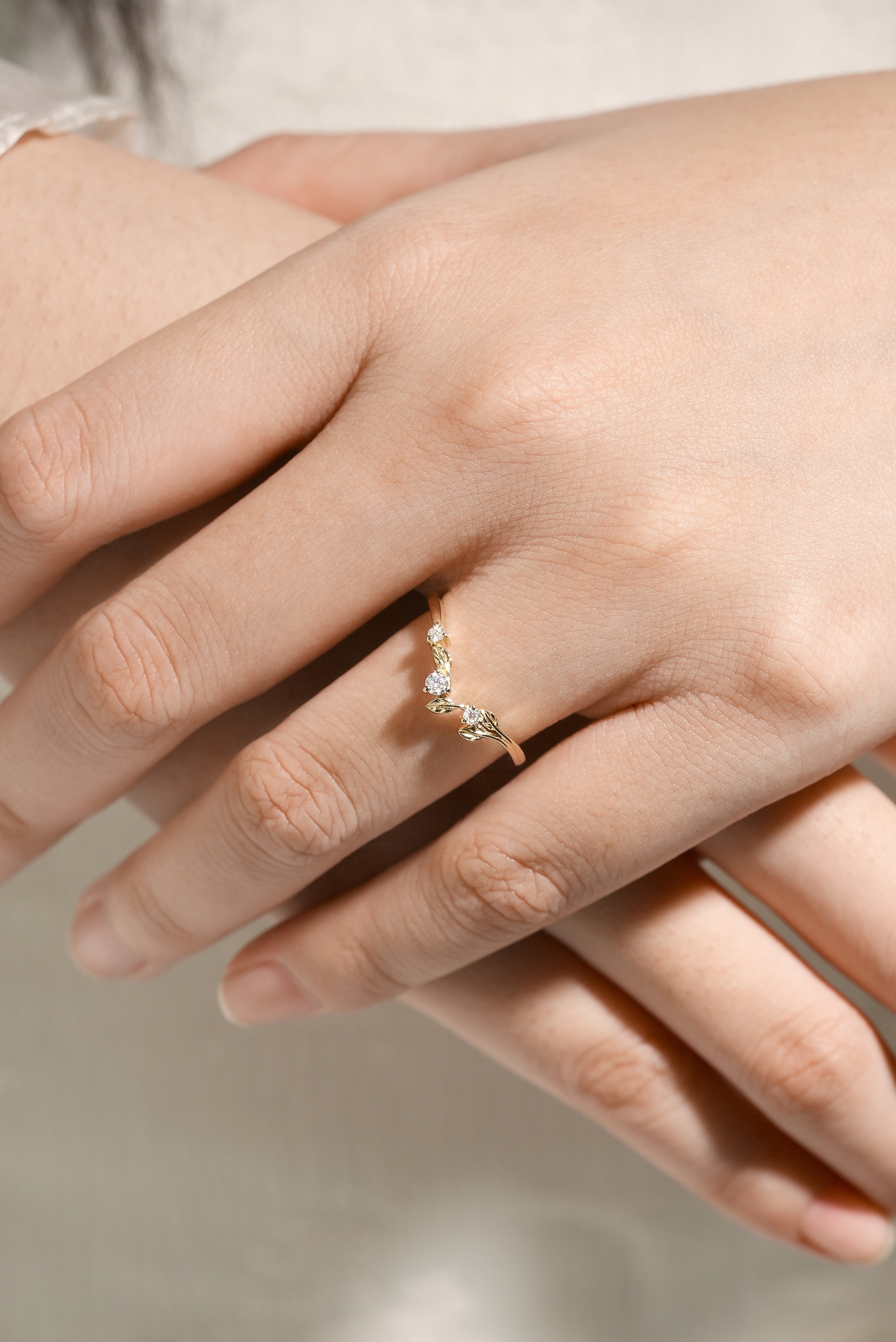 Moissanite leaf band on hand. Nature-inspired wedding ring.