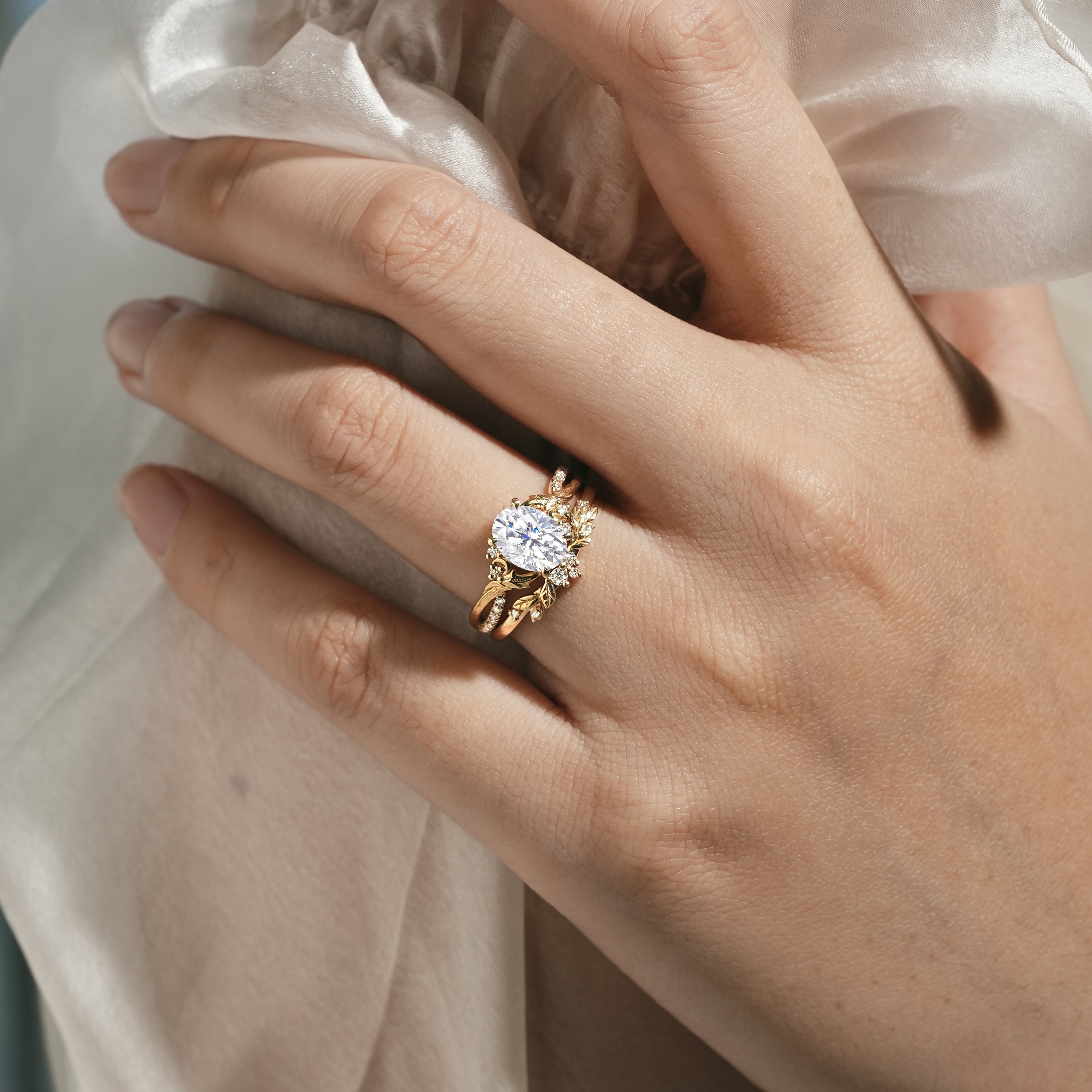 Oval moissanite engagement ring with leaf-inspired band