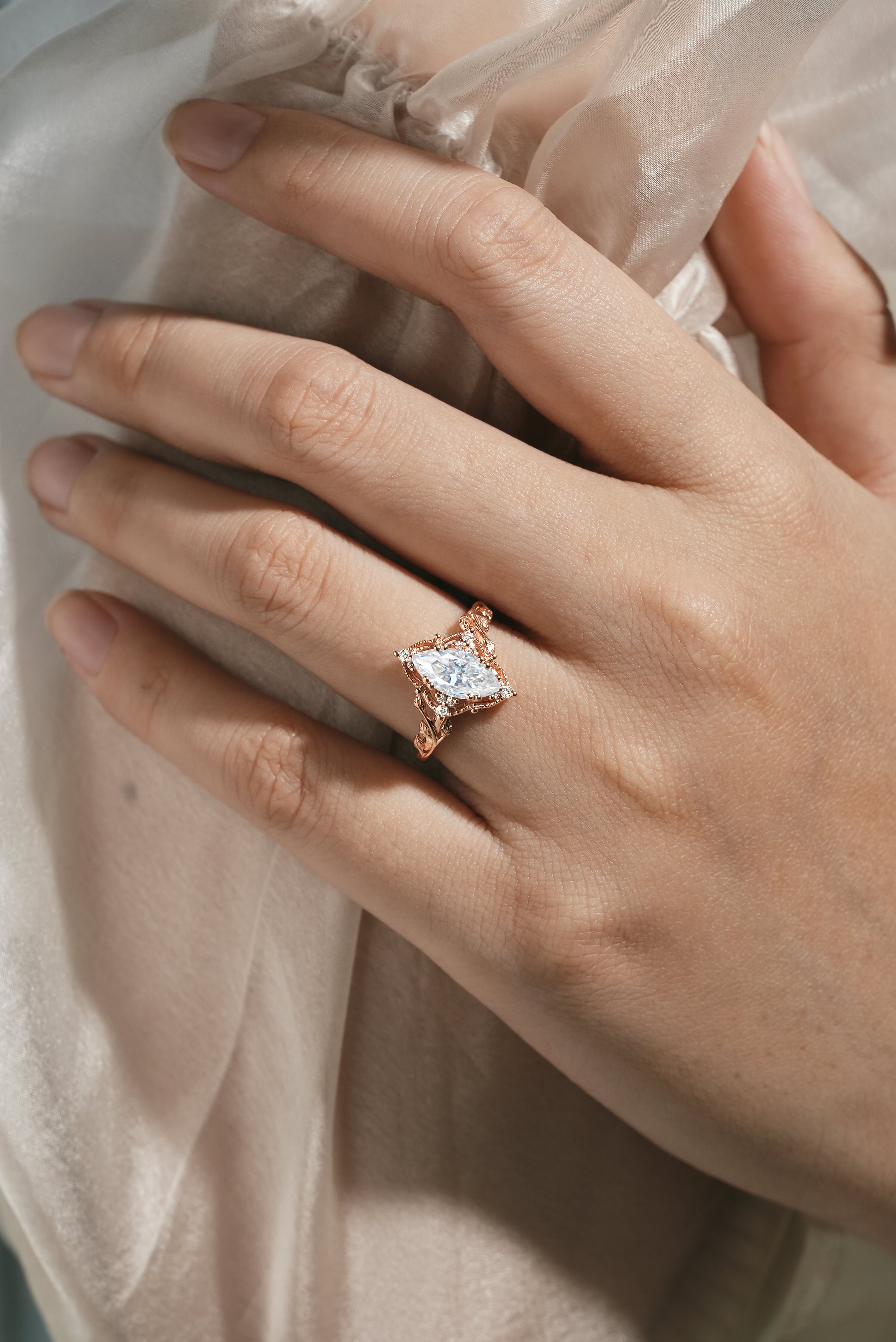 Marquise moissanite ring with leaf details, rose gold band, nature-inspired design