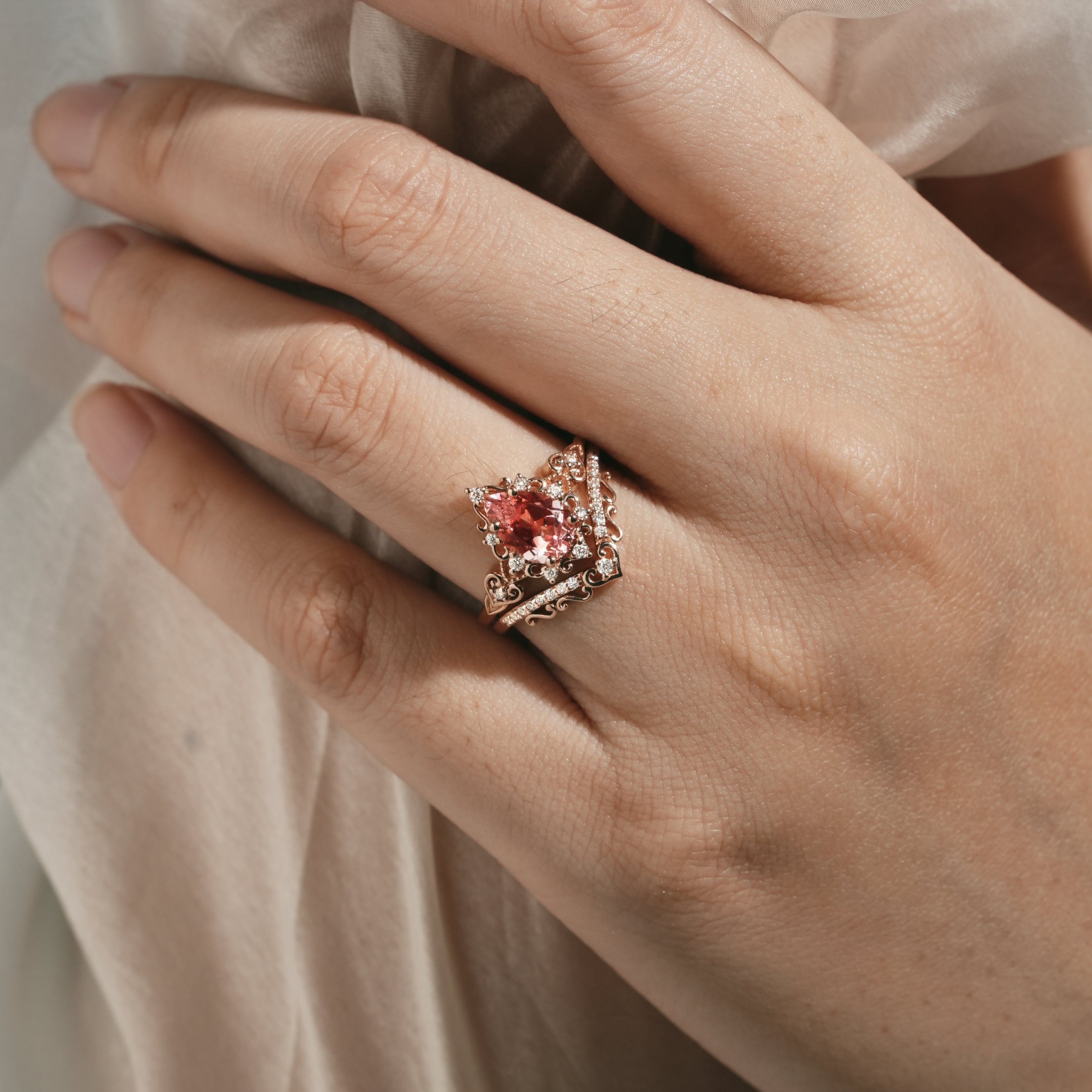 Padparadscha sapphire engagement ring on hand