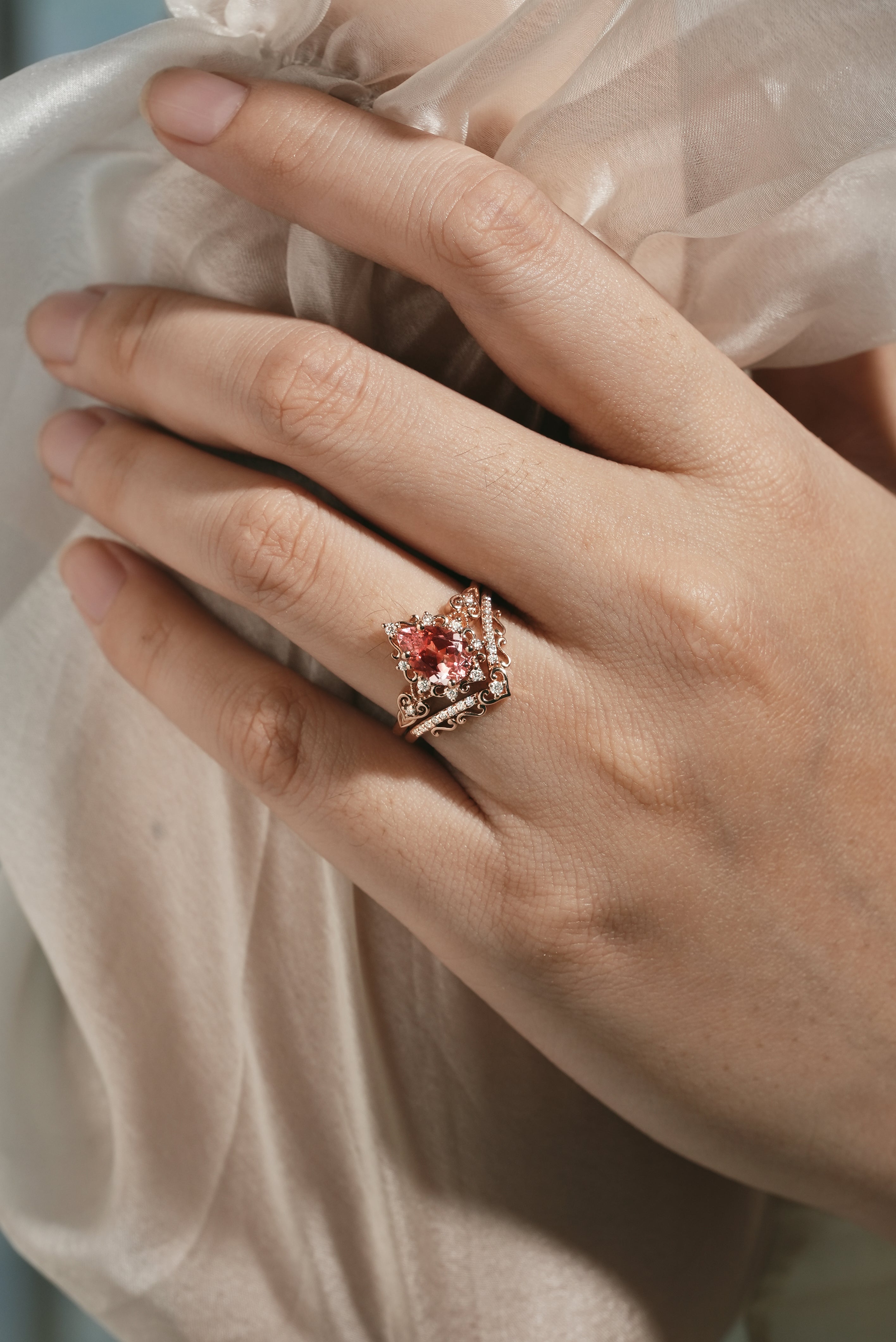 Padparadscha sapphire engagement ring on hand