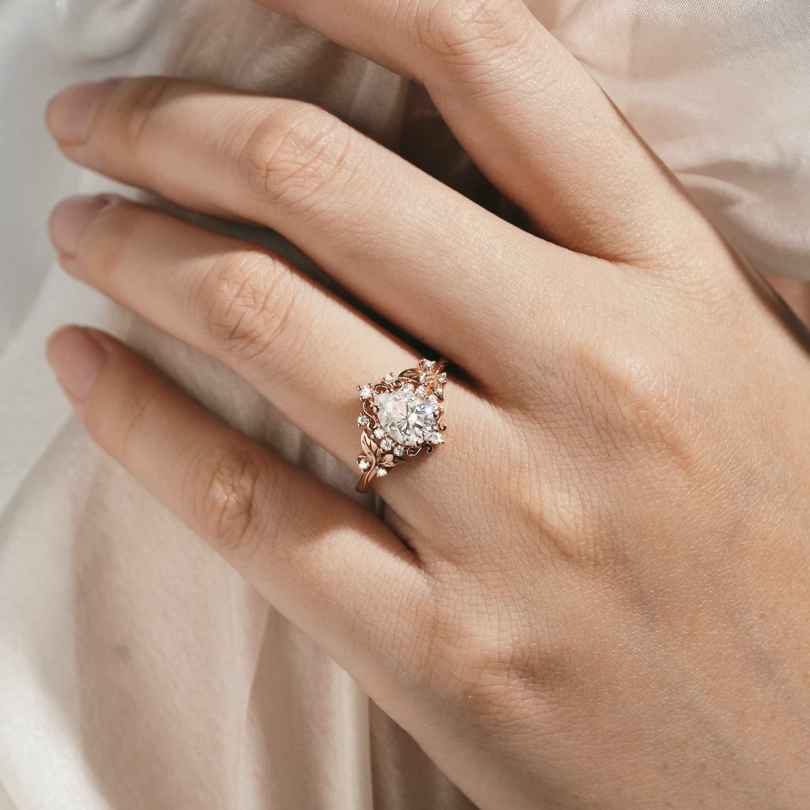 Rose gold engagement ring with leaf design and moissanite