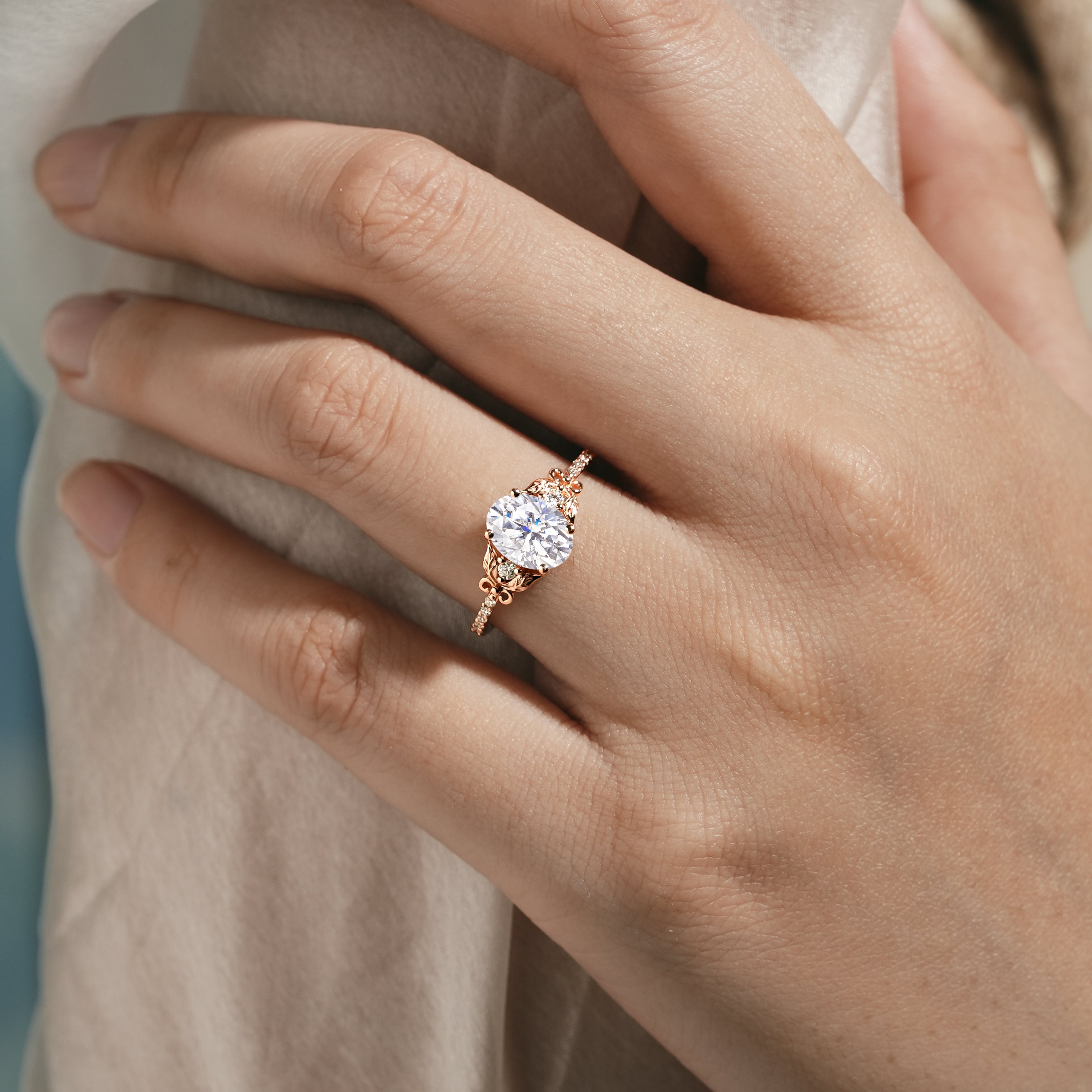 Oval Moissanite Engagement Ring on hand, leaf design
