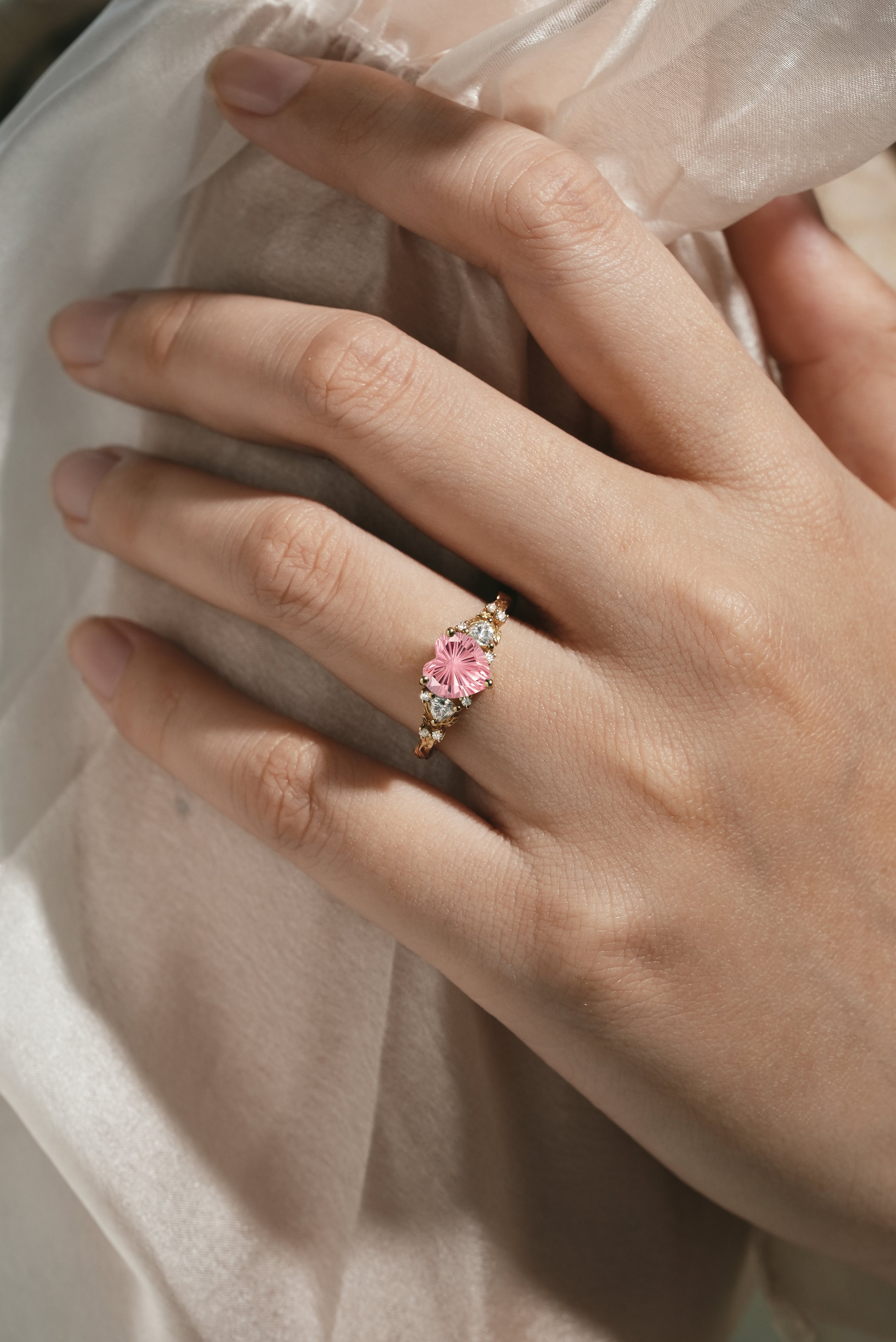 Lahela Jewelry Padparadscha Heart-Cut Engagement Ring on a hand