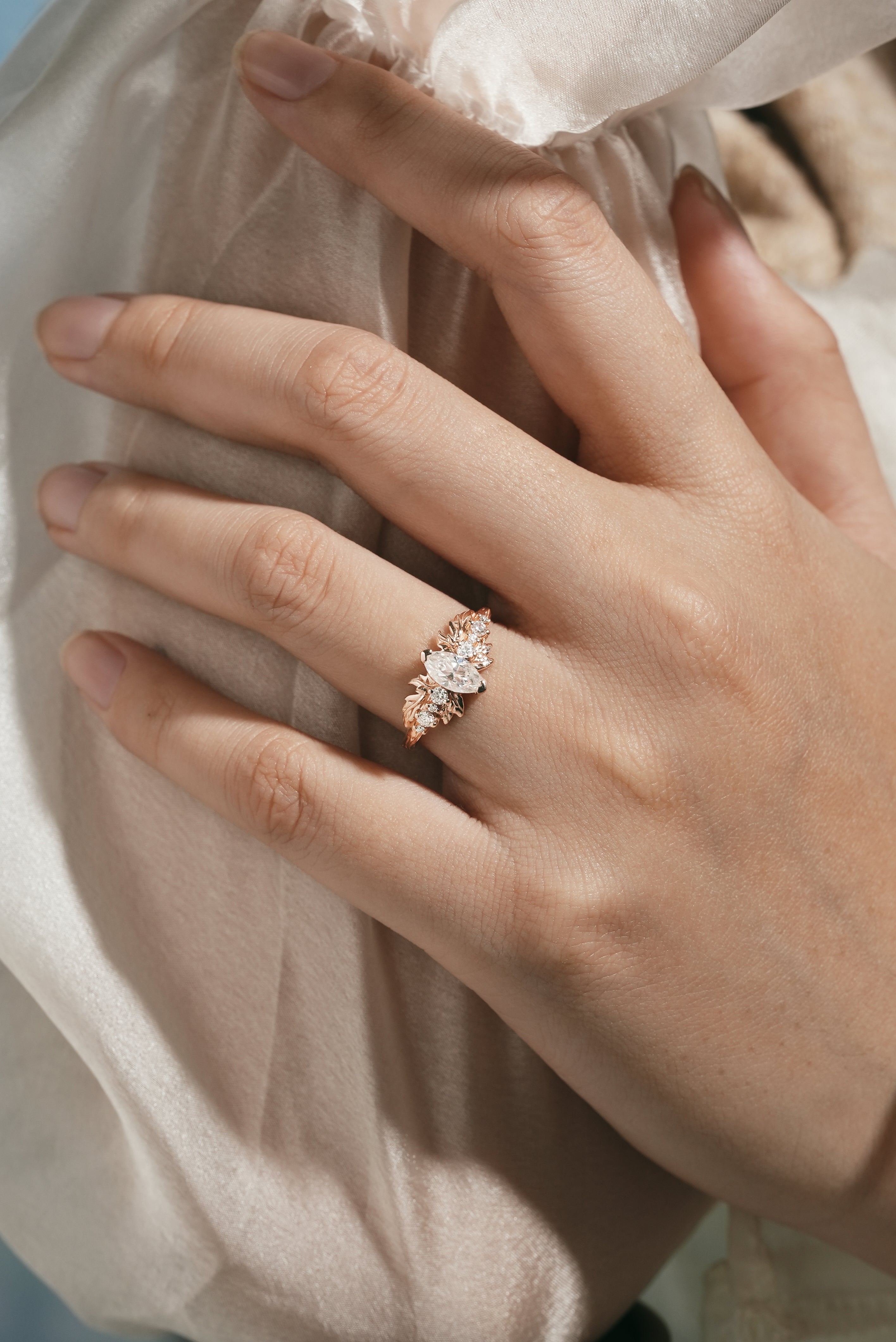 Elegant marquise moissanite engagement ring on a hand