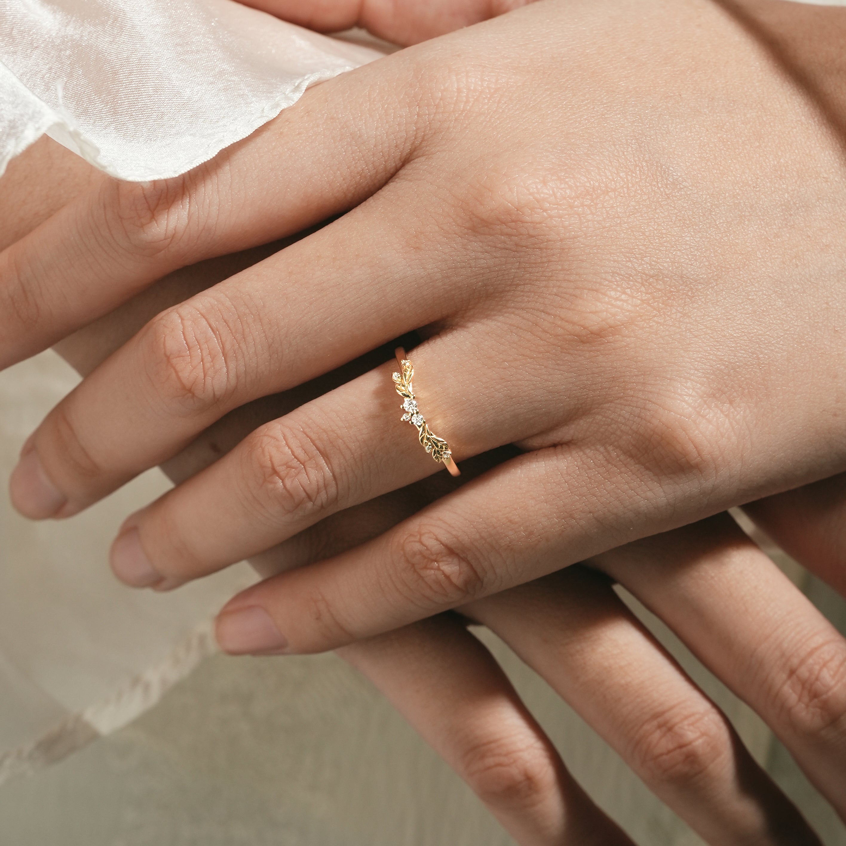 Elegant leaf pattern wedding band on hand, nature-inspired design