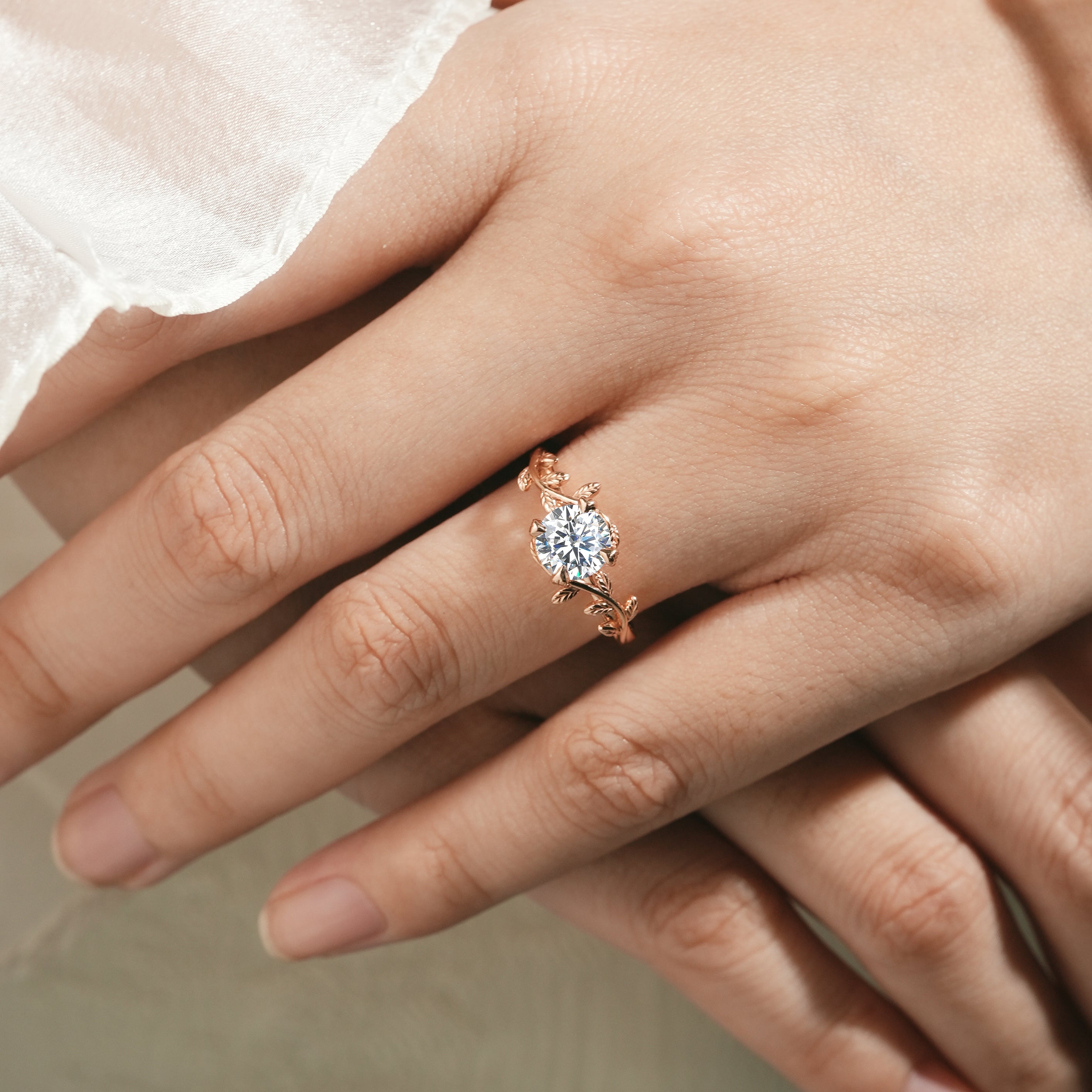 Woman wearing a round moissanite leaf engagement ring