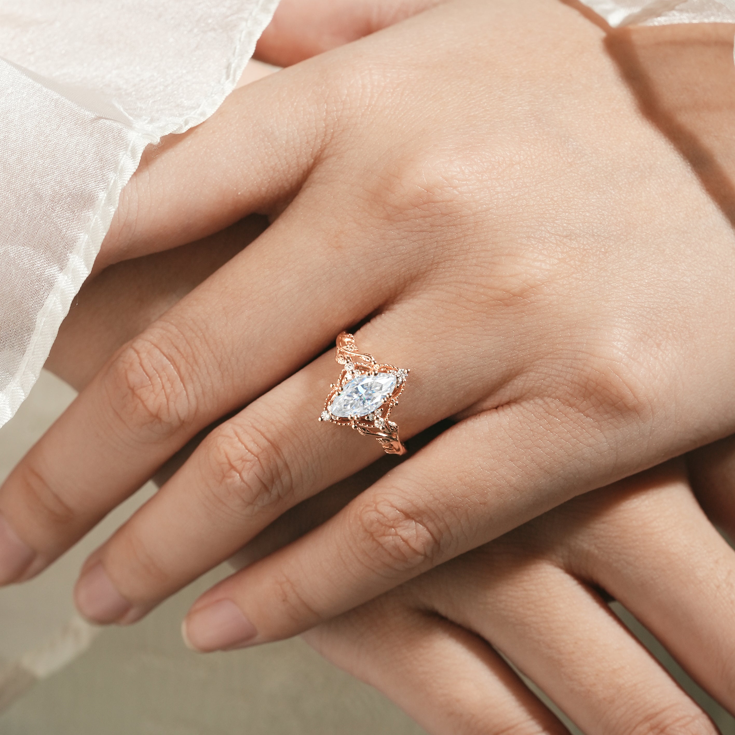 Marquise moissanite ring with leaf design on hand