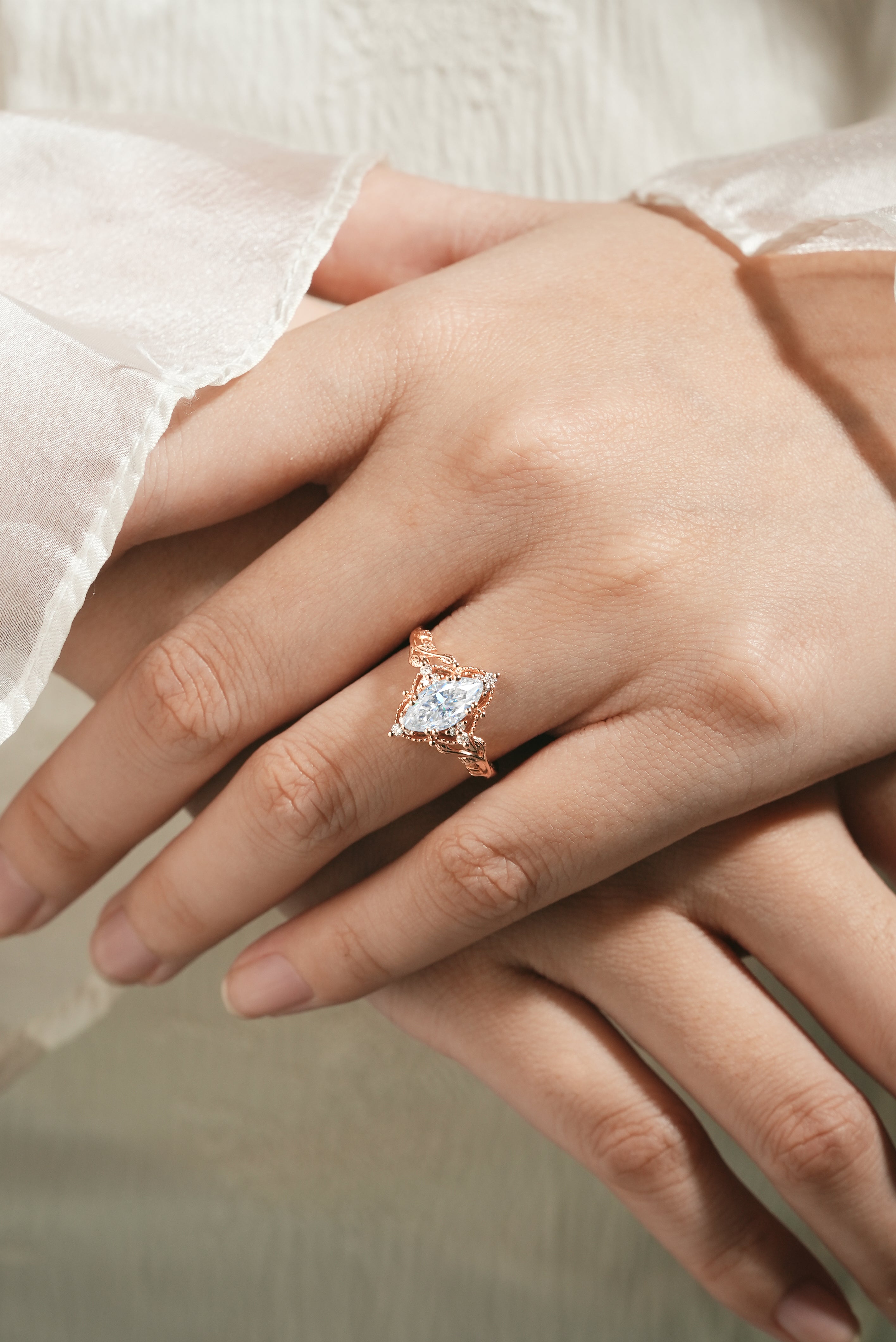 Marquise moissanite ring with leaf design on hand