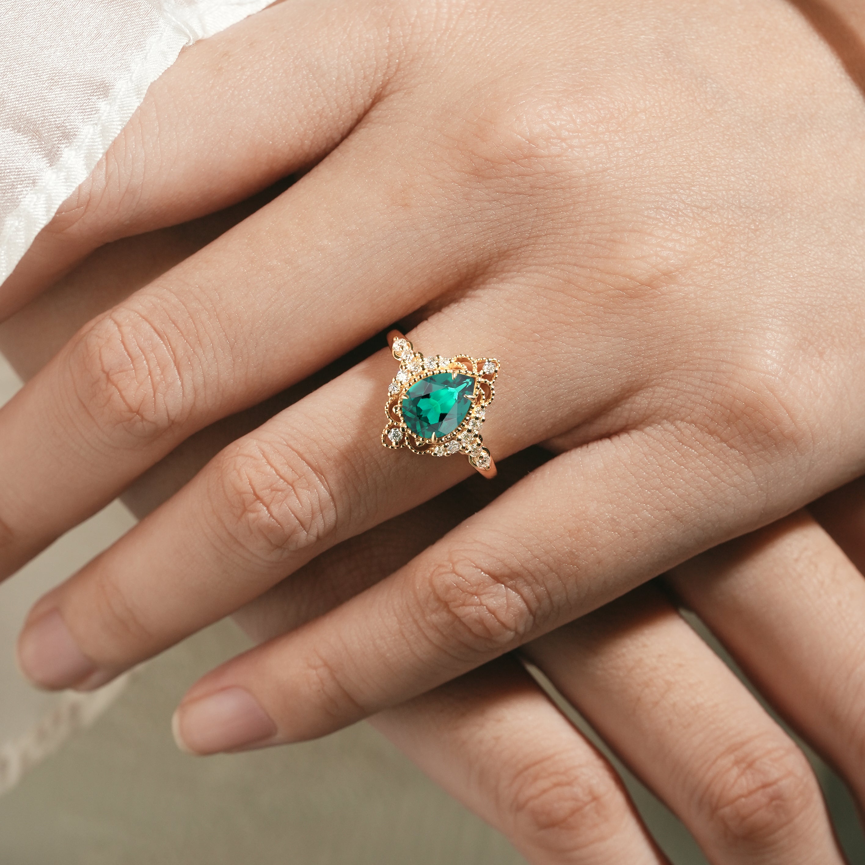 Hand wearing Pear Cut Emerald Palace Ring