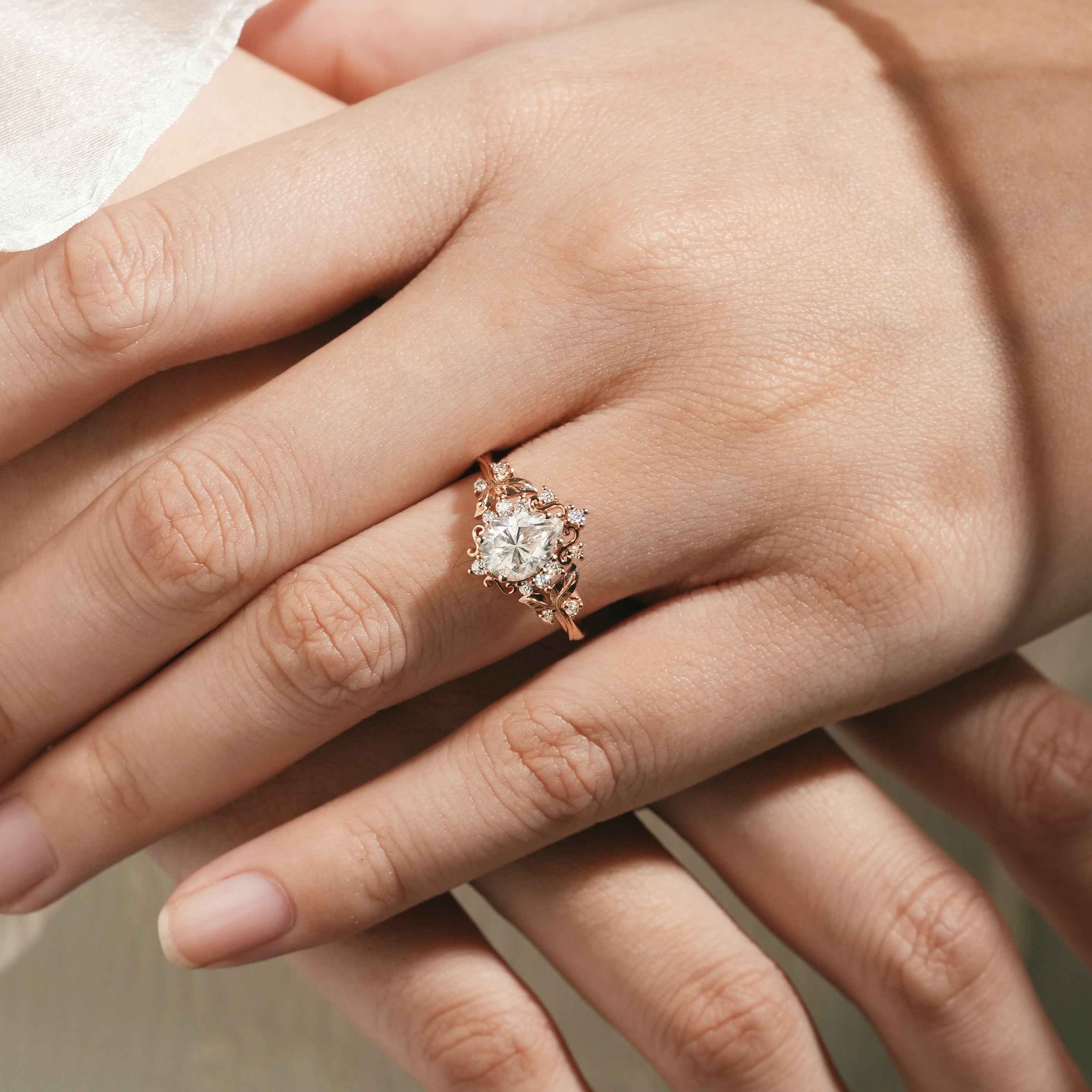 Hand with leaf-inspired engagement ring