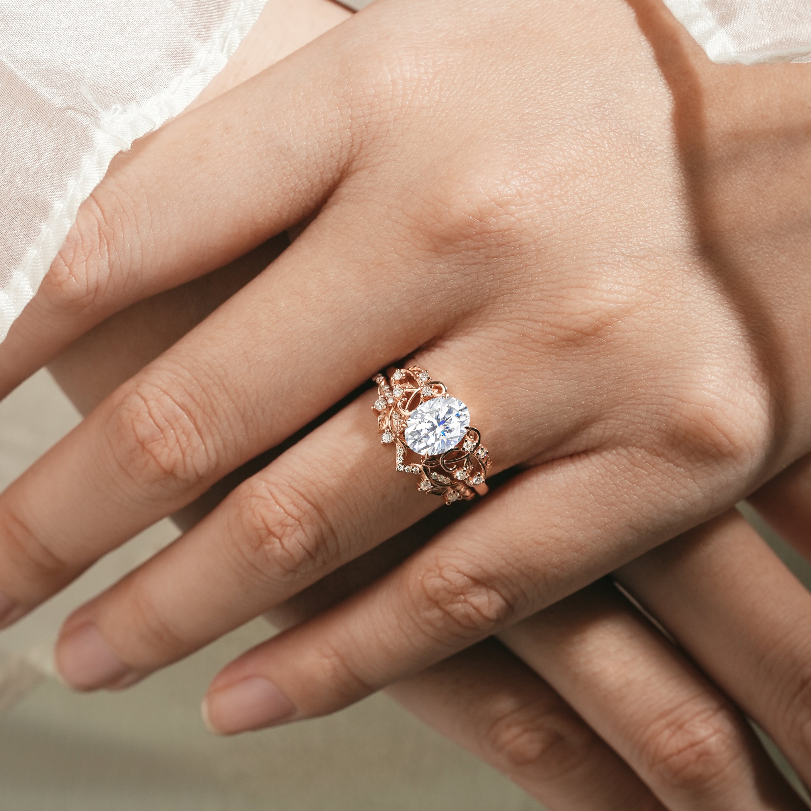 Oval moissanite leaf engagement ring set on hand, Rose gold