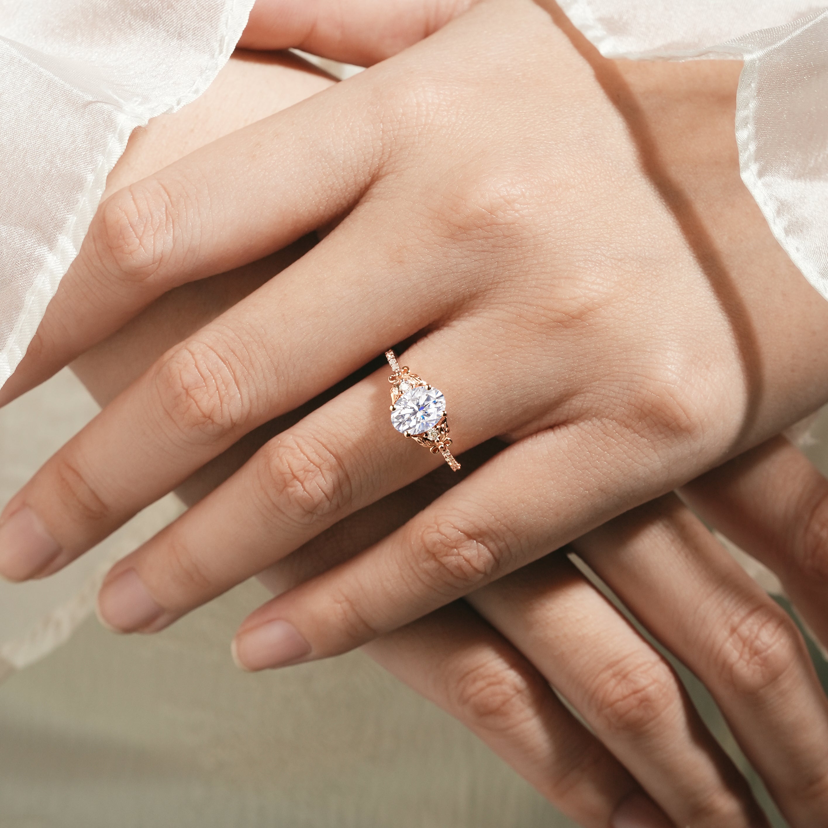 Rose gold leaf engagement ring with round moissanite on hand