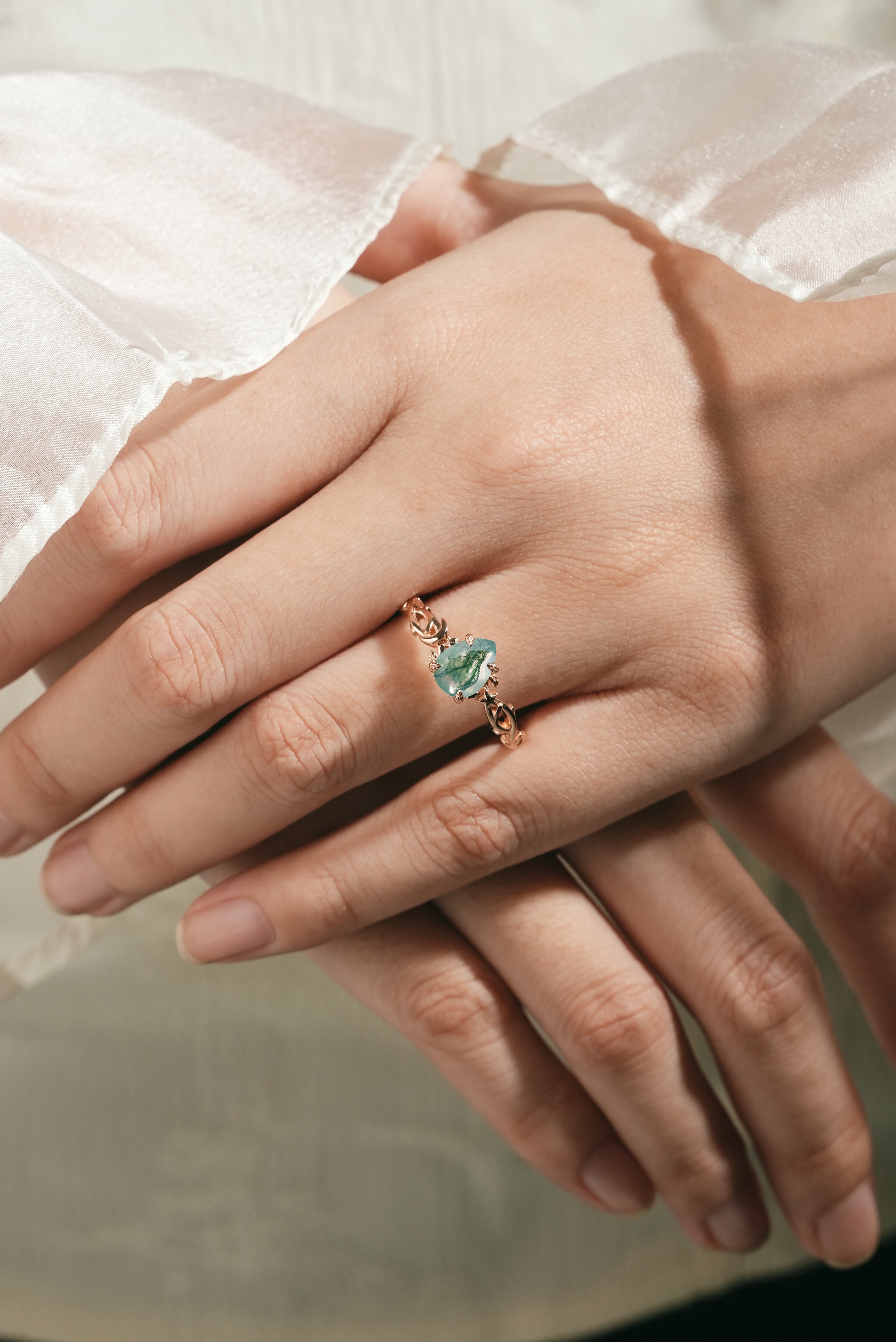 Moss Agate Pear Cut Engagement Ring on hand, nature-inspired design