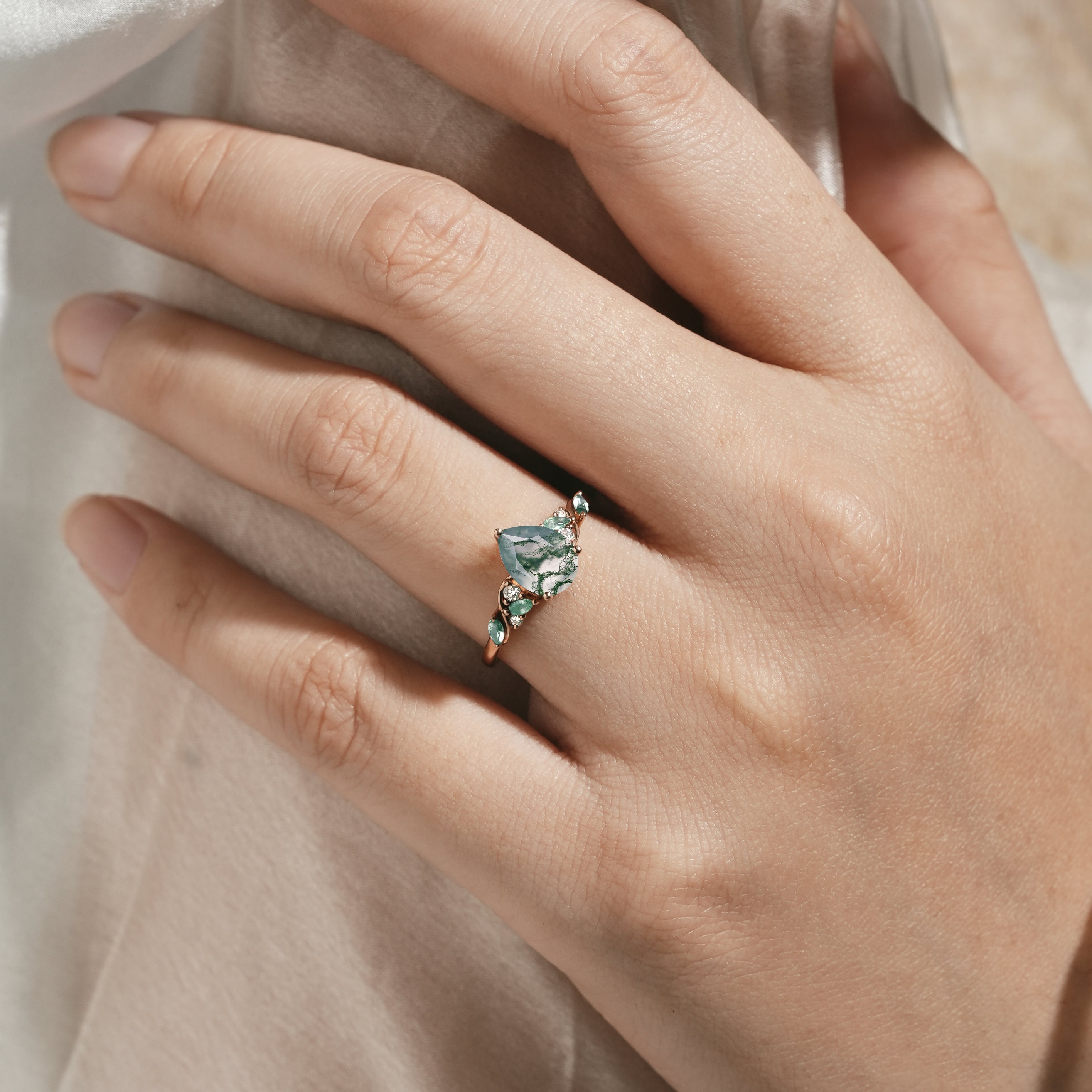 Nature-inspired pear cut moss agate engagement ring with moissanite accents